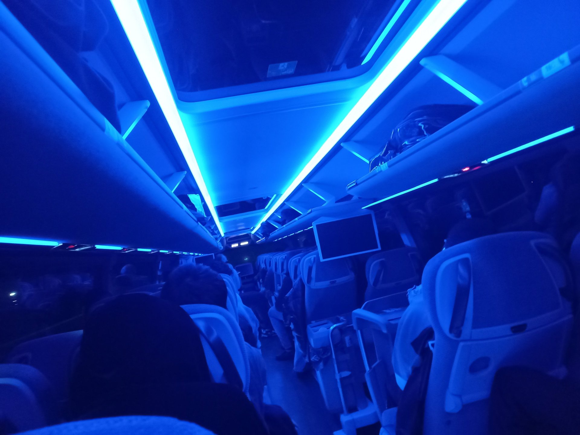 a narrow alley with a sign on the side of it