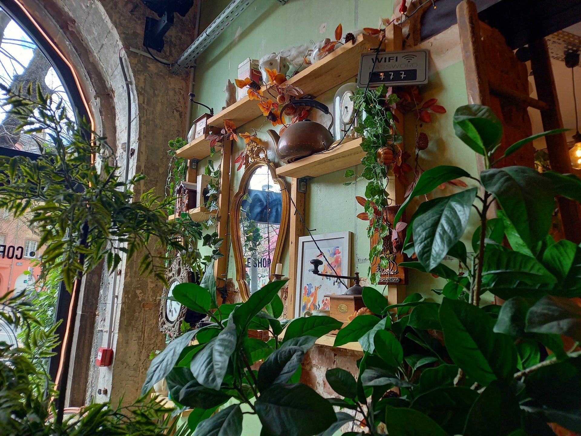 a narrow alley with a sign on the side of it