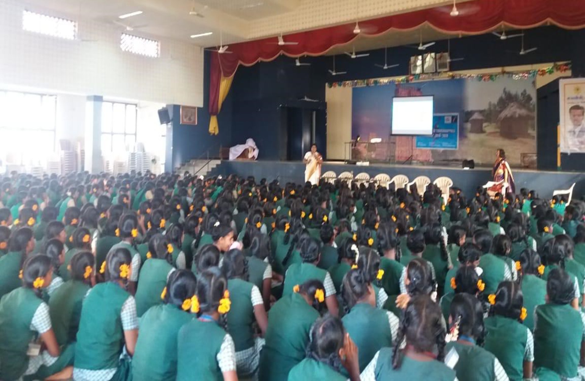 five children smiling while doing peace hand sign
