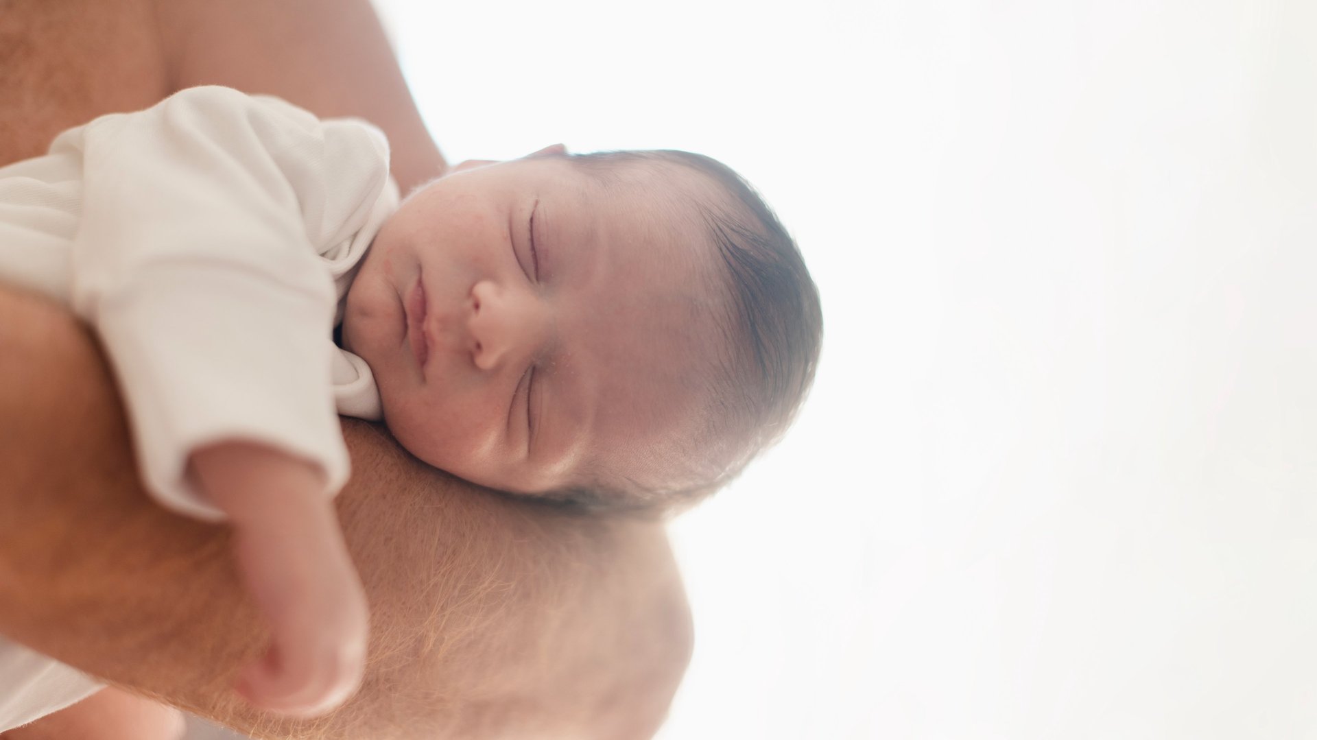 baby lying on fabric cloth