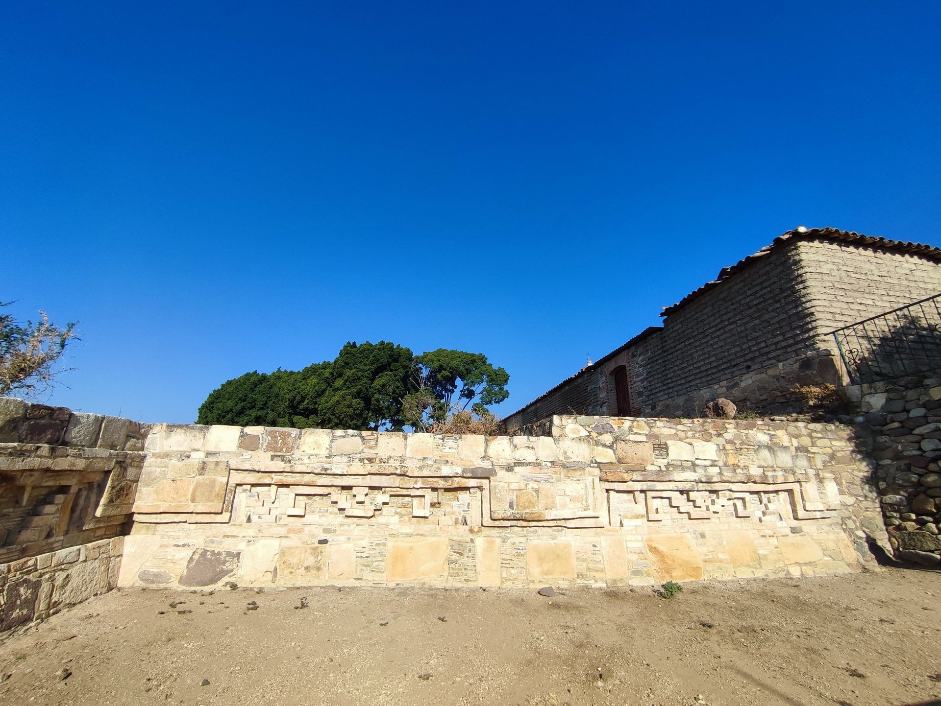 an abstract photo of a curved building with a blue sky in the background