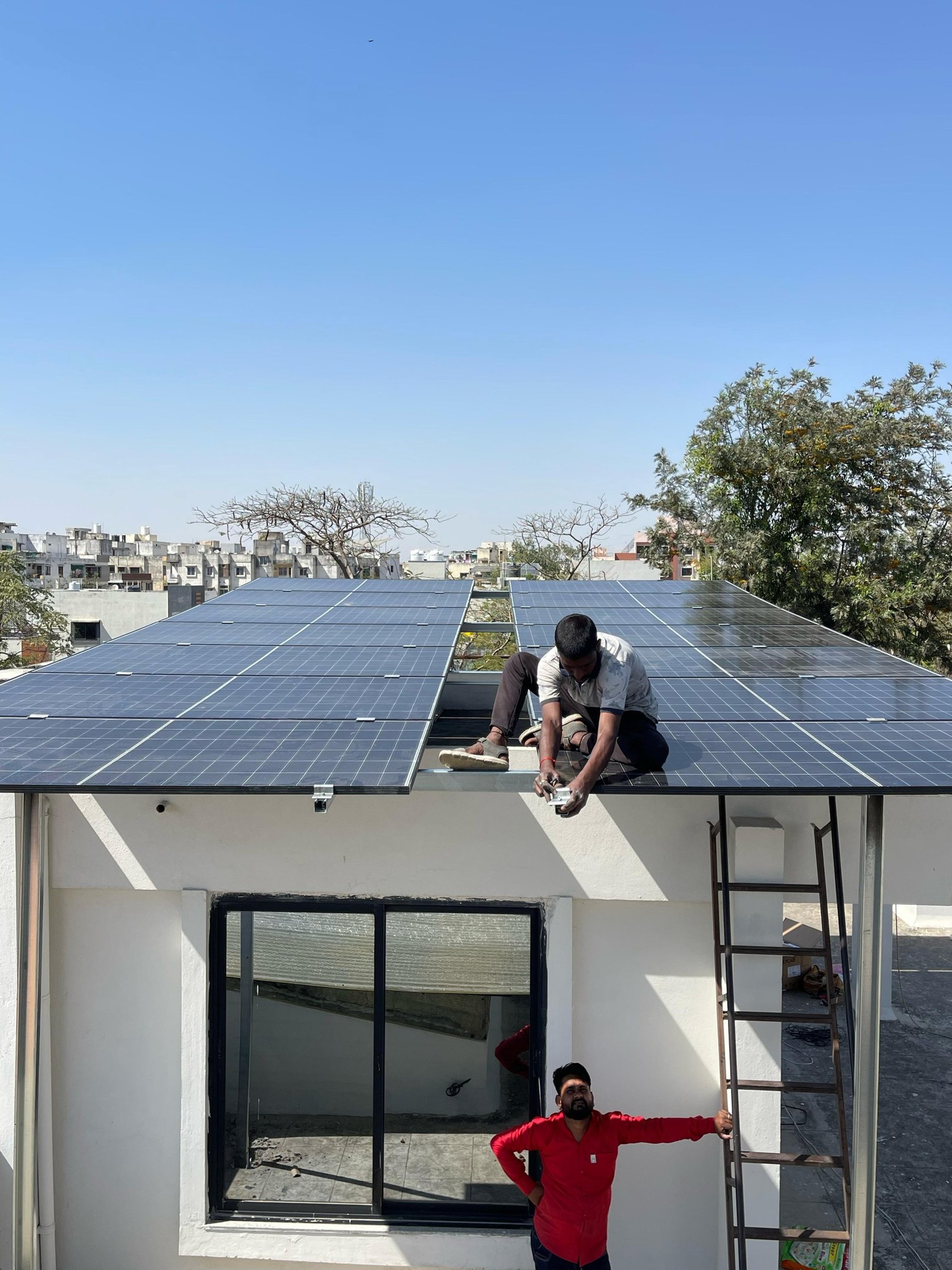 man holding solar panel on roof