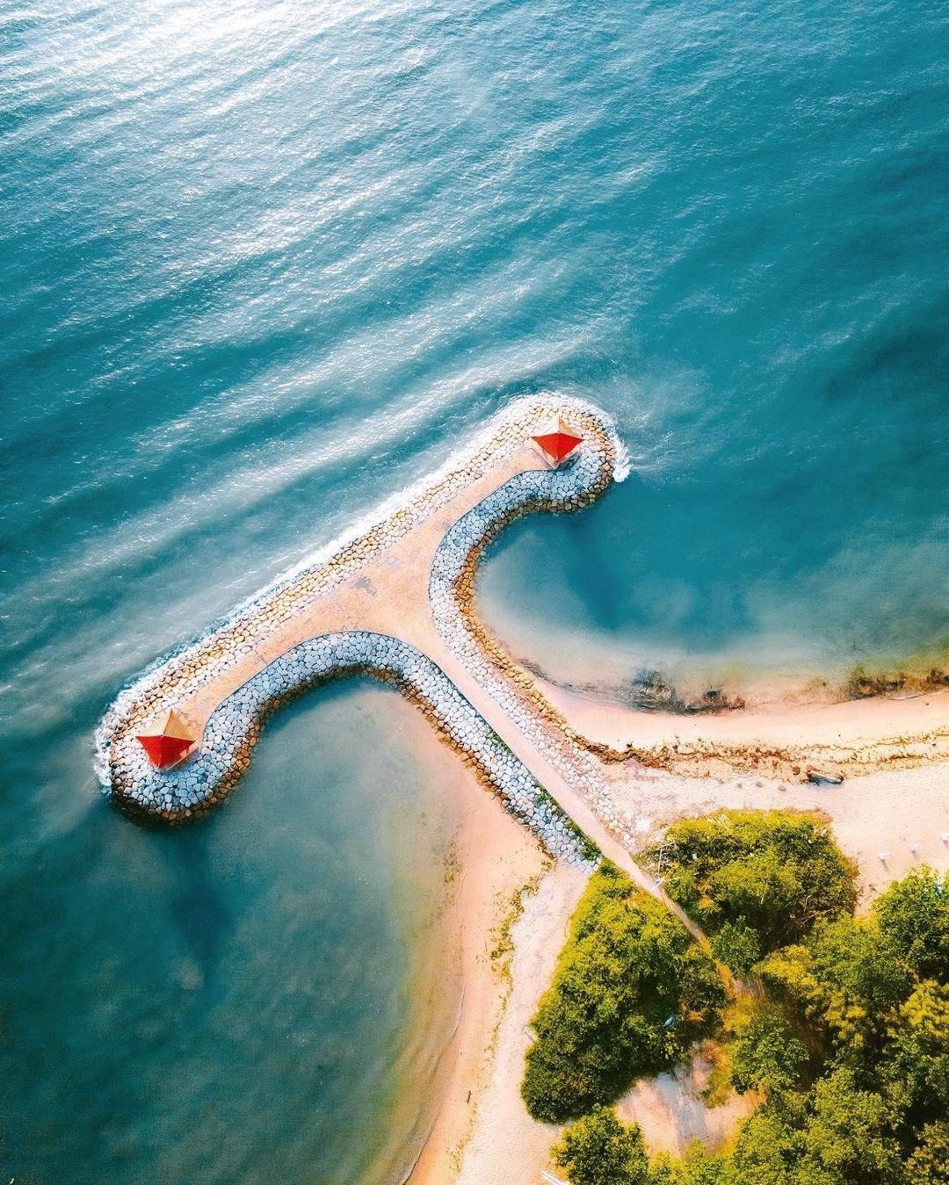 temple beside body of water and trees