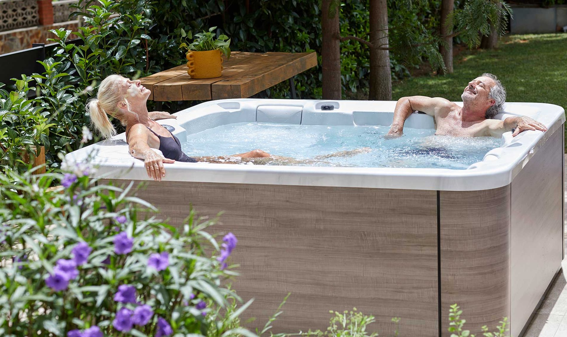 woman peeking over green leaf plant taken at daytime