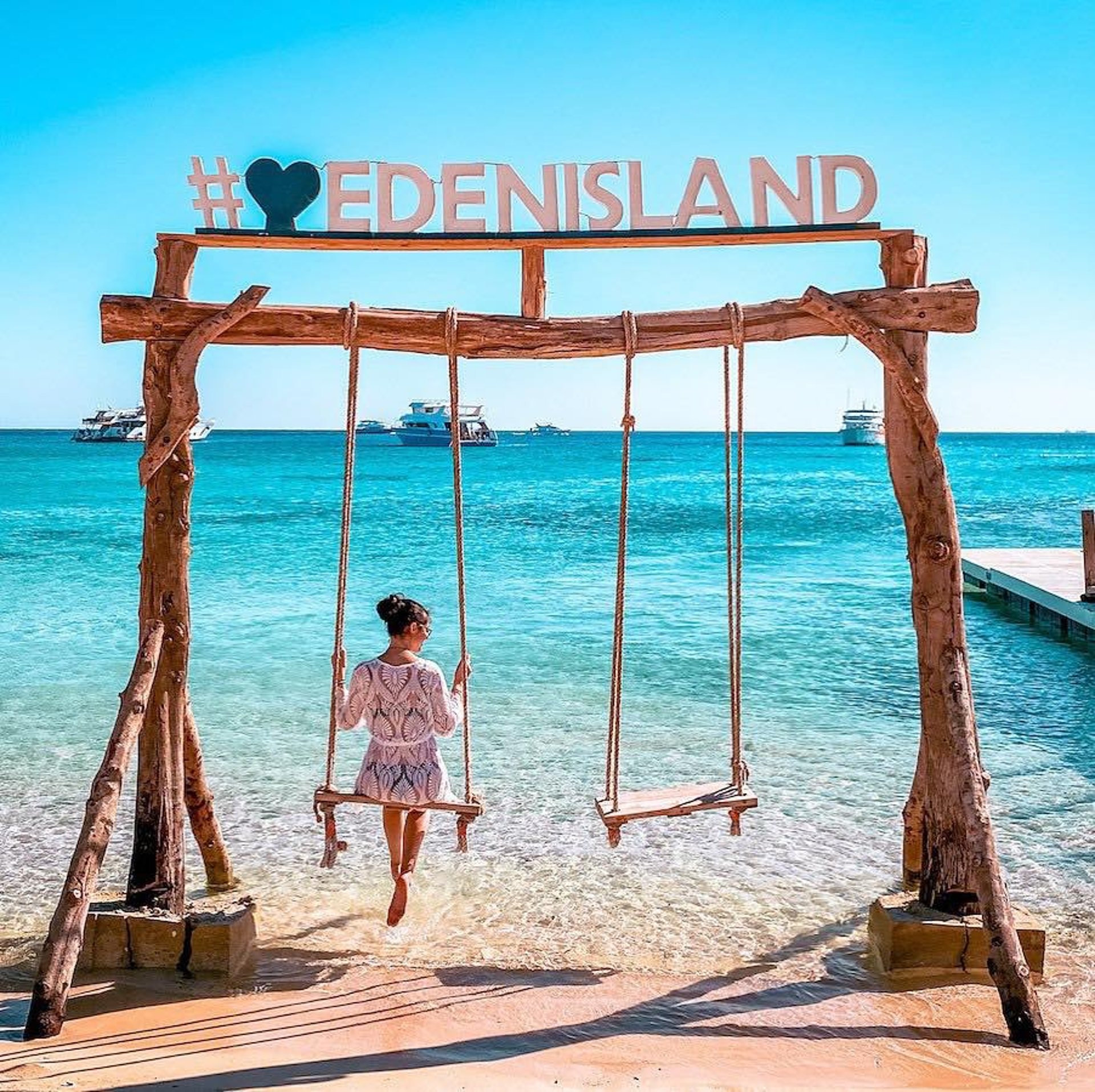 woman wearing yellow long-sleeved dress under white clouds and blue sky during daytime