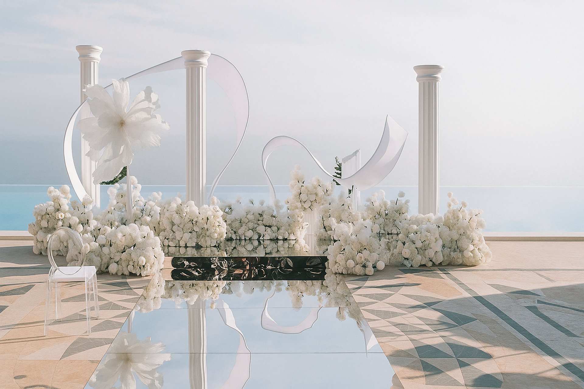 a white building with a door and a sky background