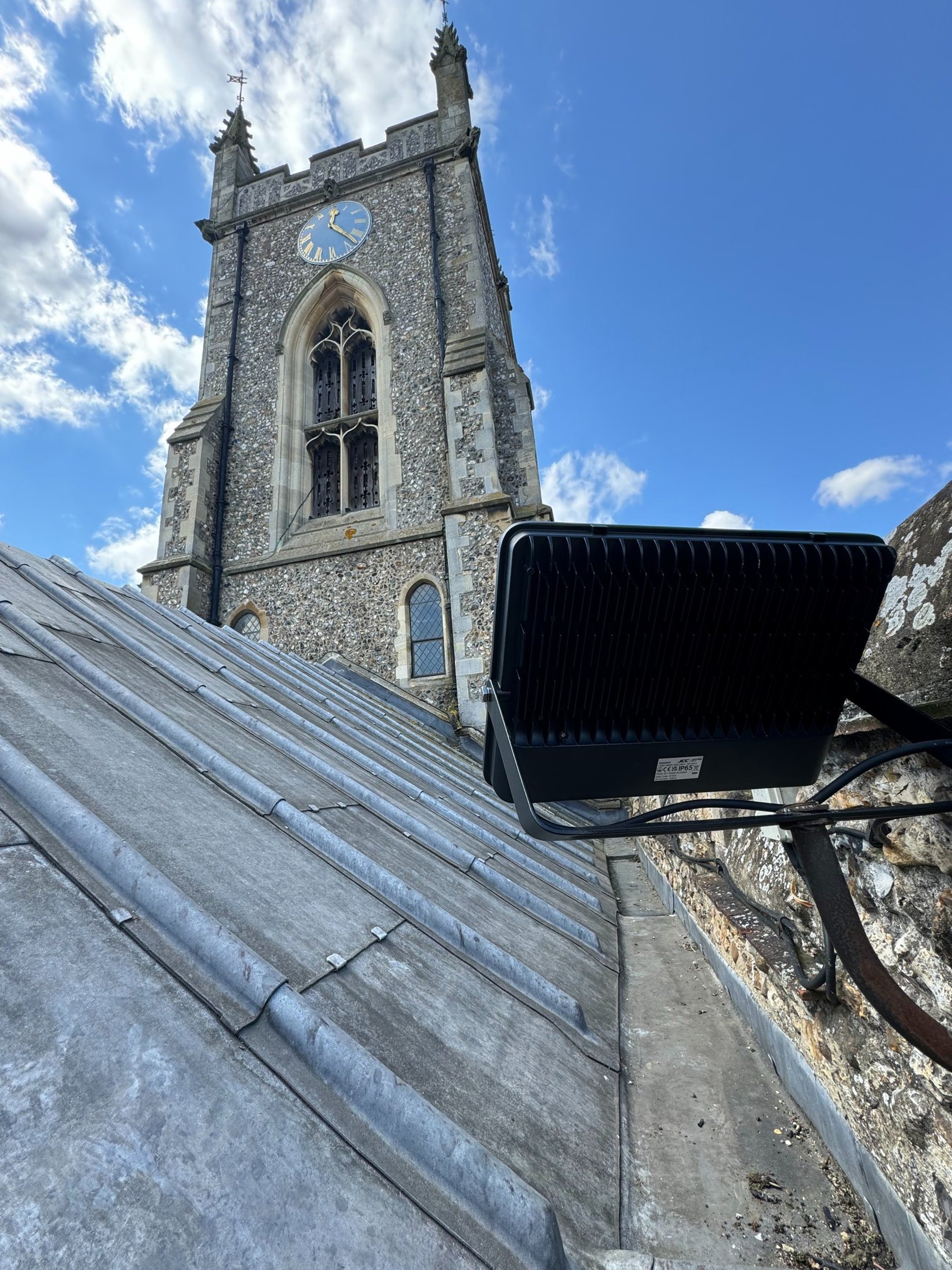 a lighthouse on top of a hill next to a beach