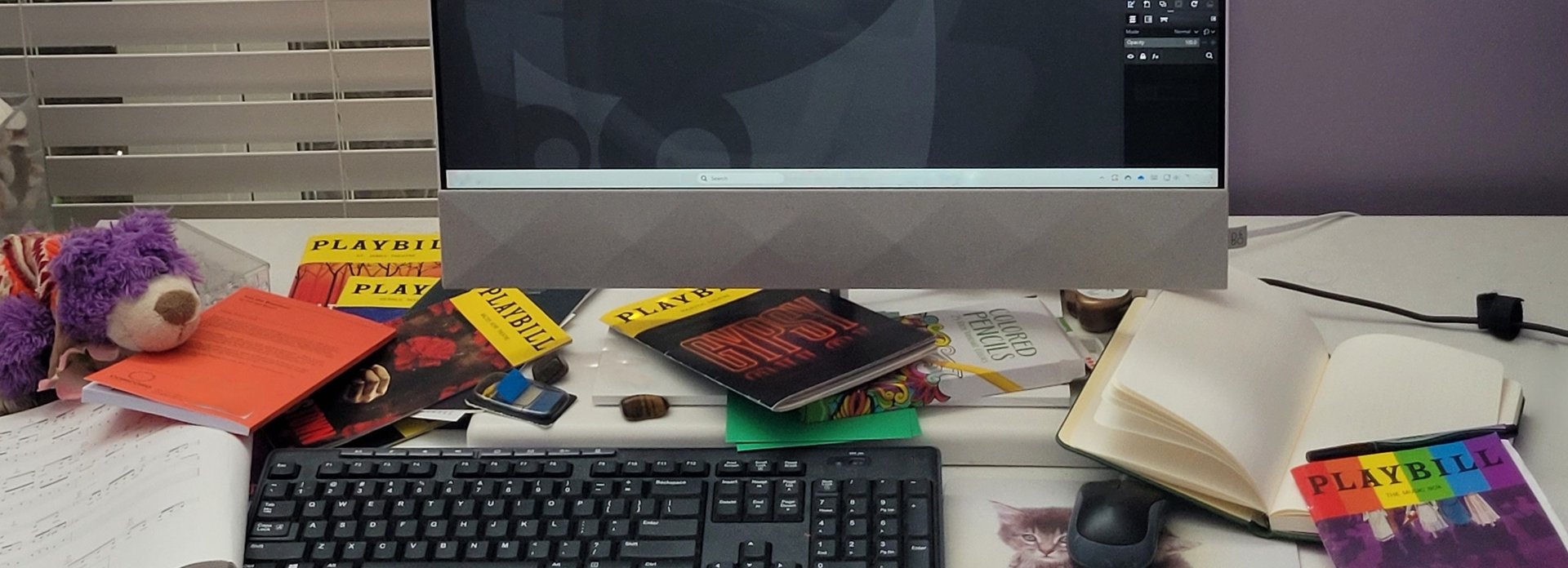 a woman standing in front of a rainbow colored wall