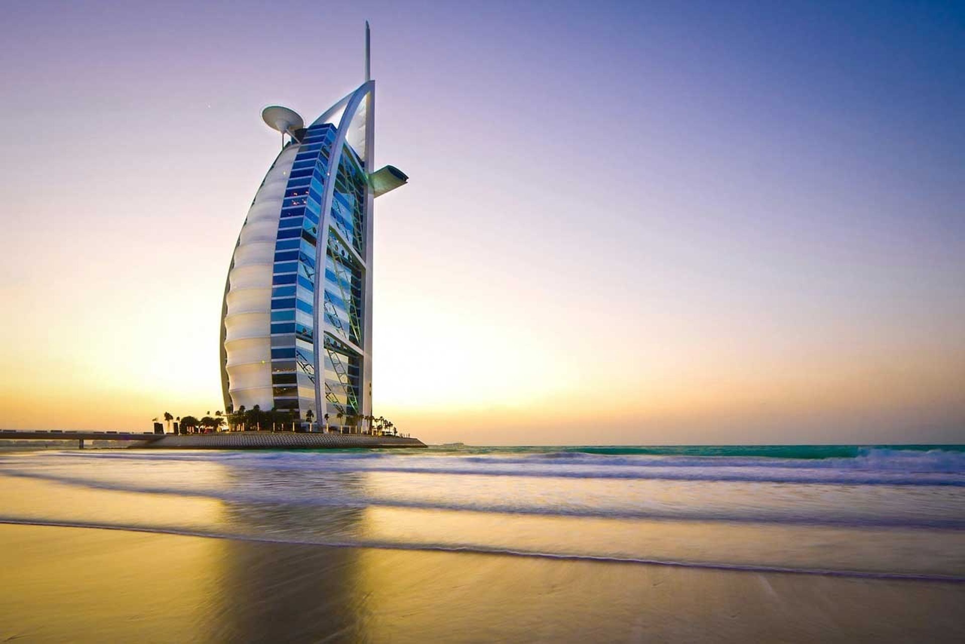 Burj Al Arab in Dubai captured at sunset, symbolizing luxury, architectural excellence, and the city’s prime real estate mark