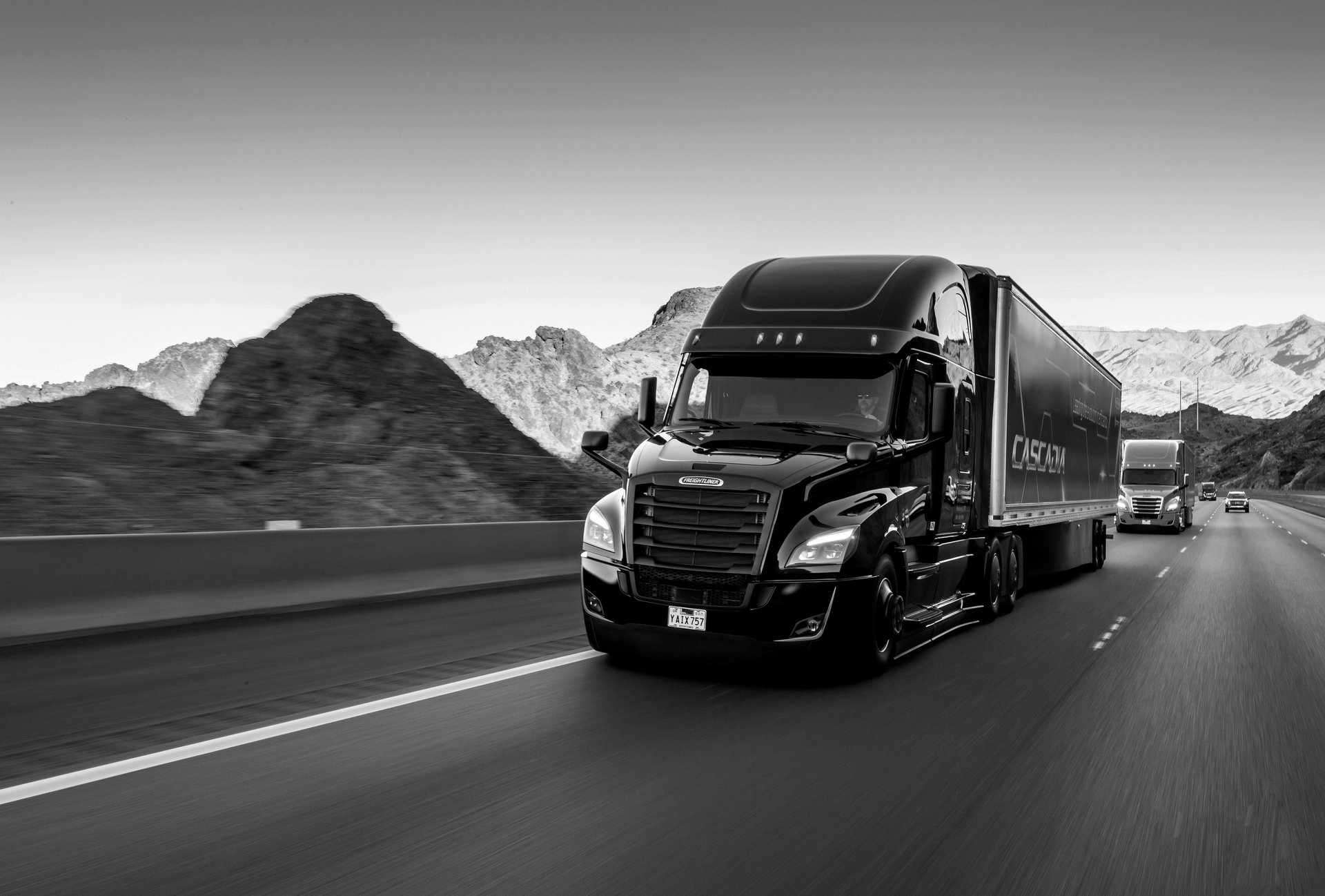 white freight truck on road during daytime