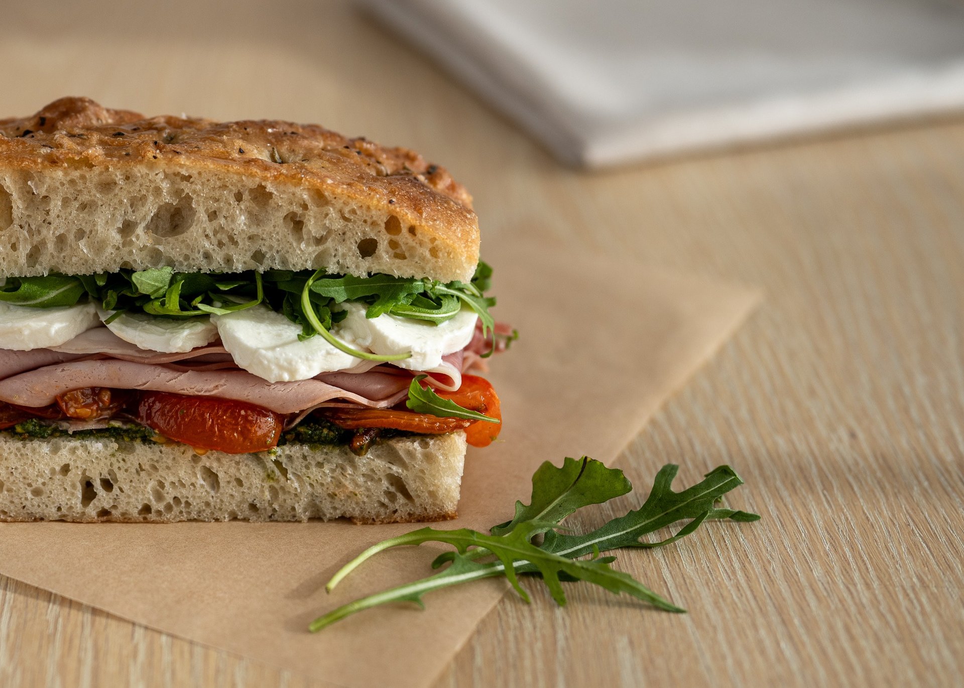 a cut in half sandwich sitting on top of a cutting board