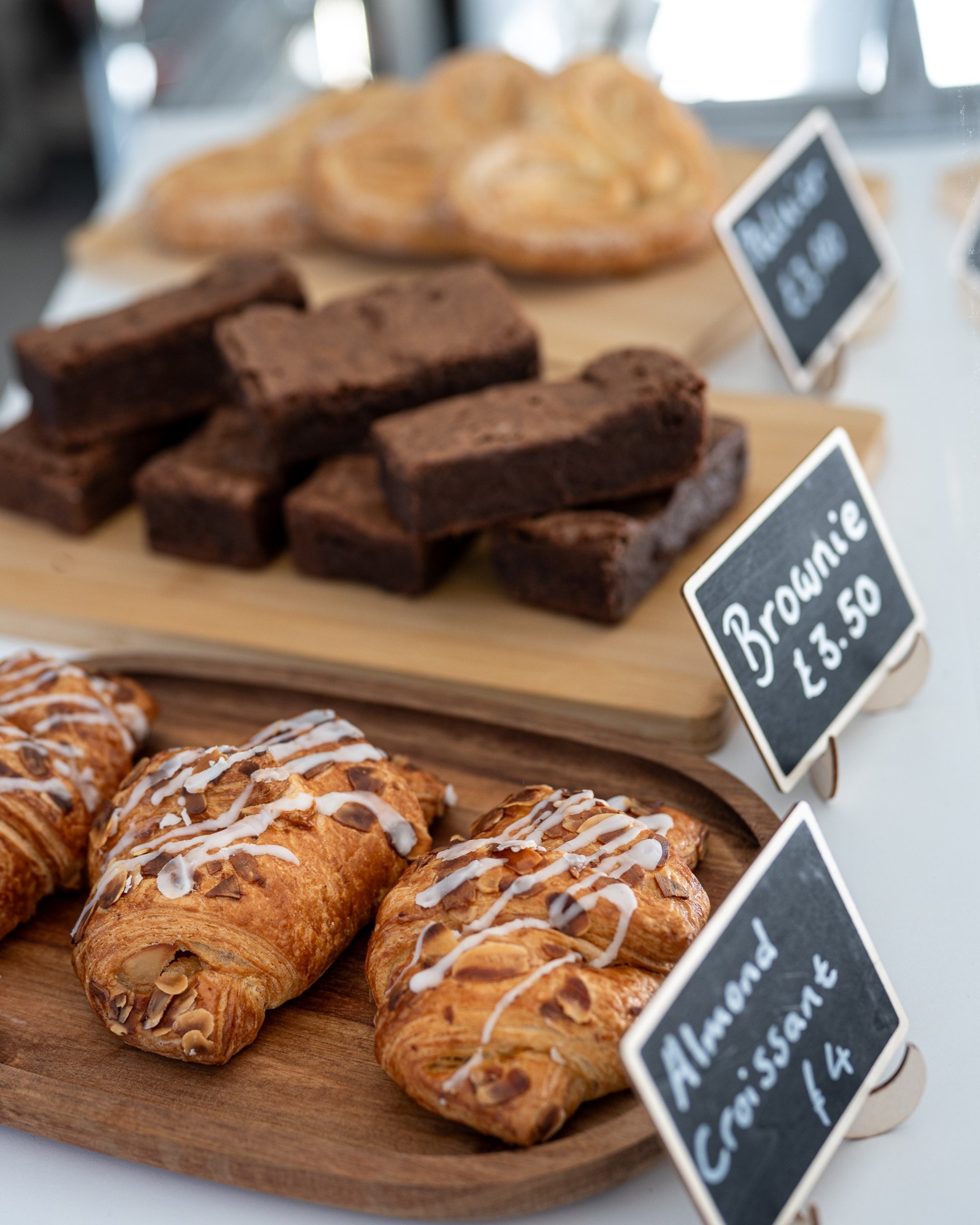 person holding white and blue floral ceramic mug