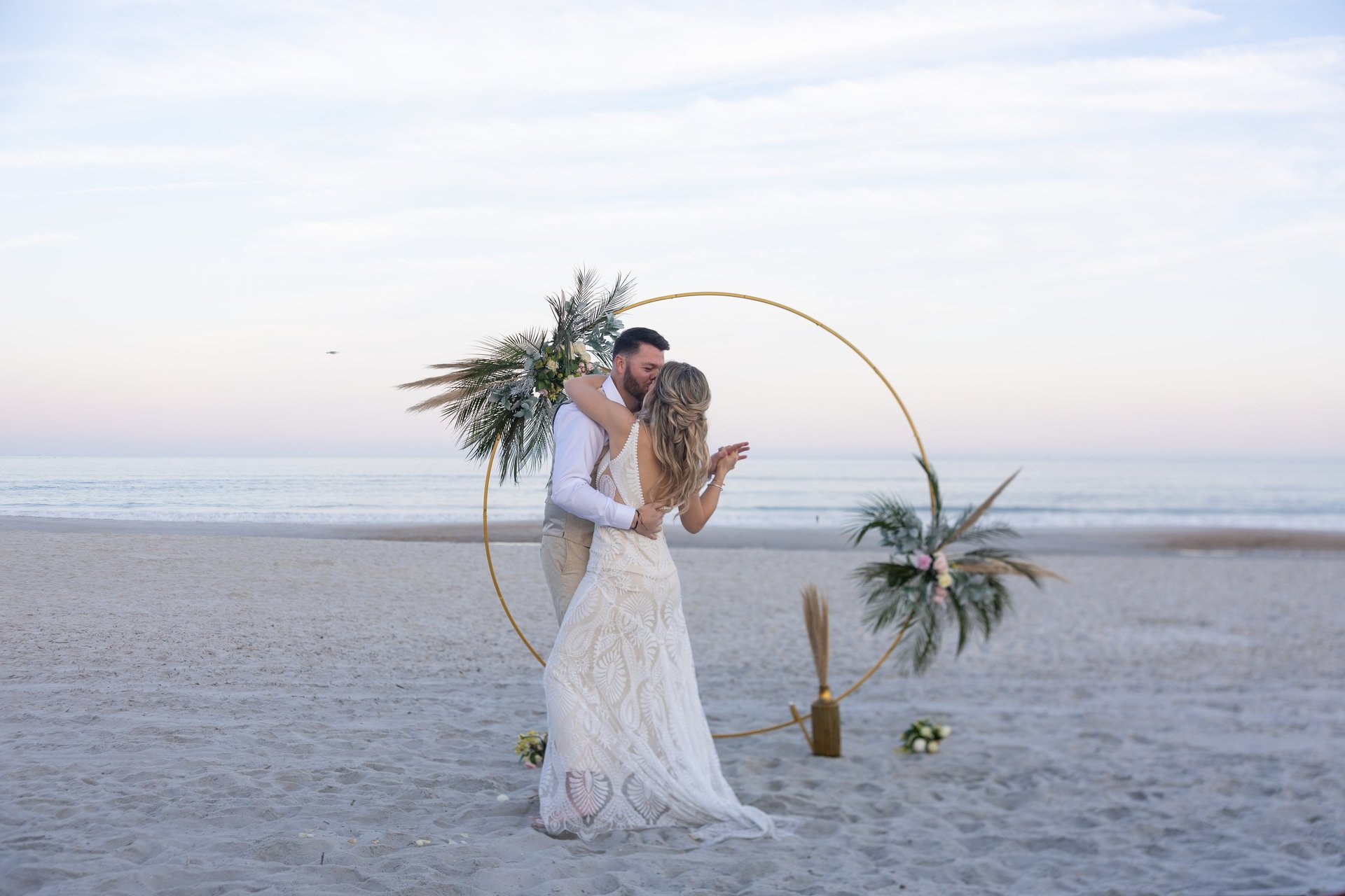 woman and man standing in front of shoreline