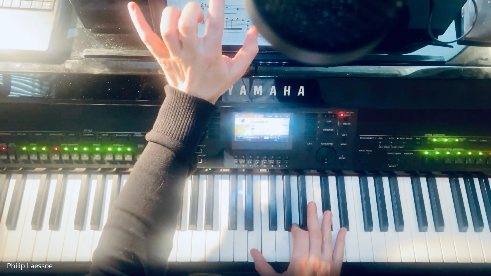 man in blue denim jacket playing piano