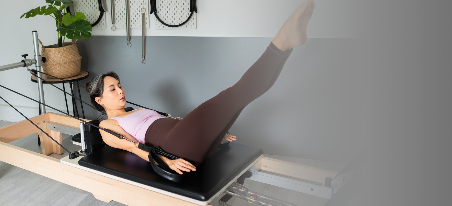 a woman is doing exercises on a rowing machine