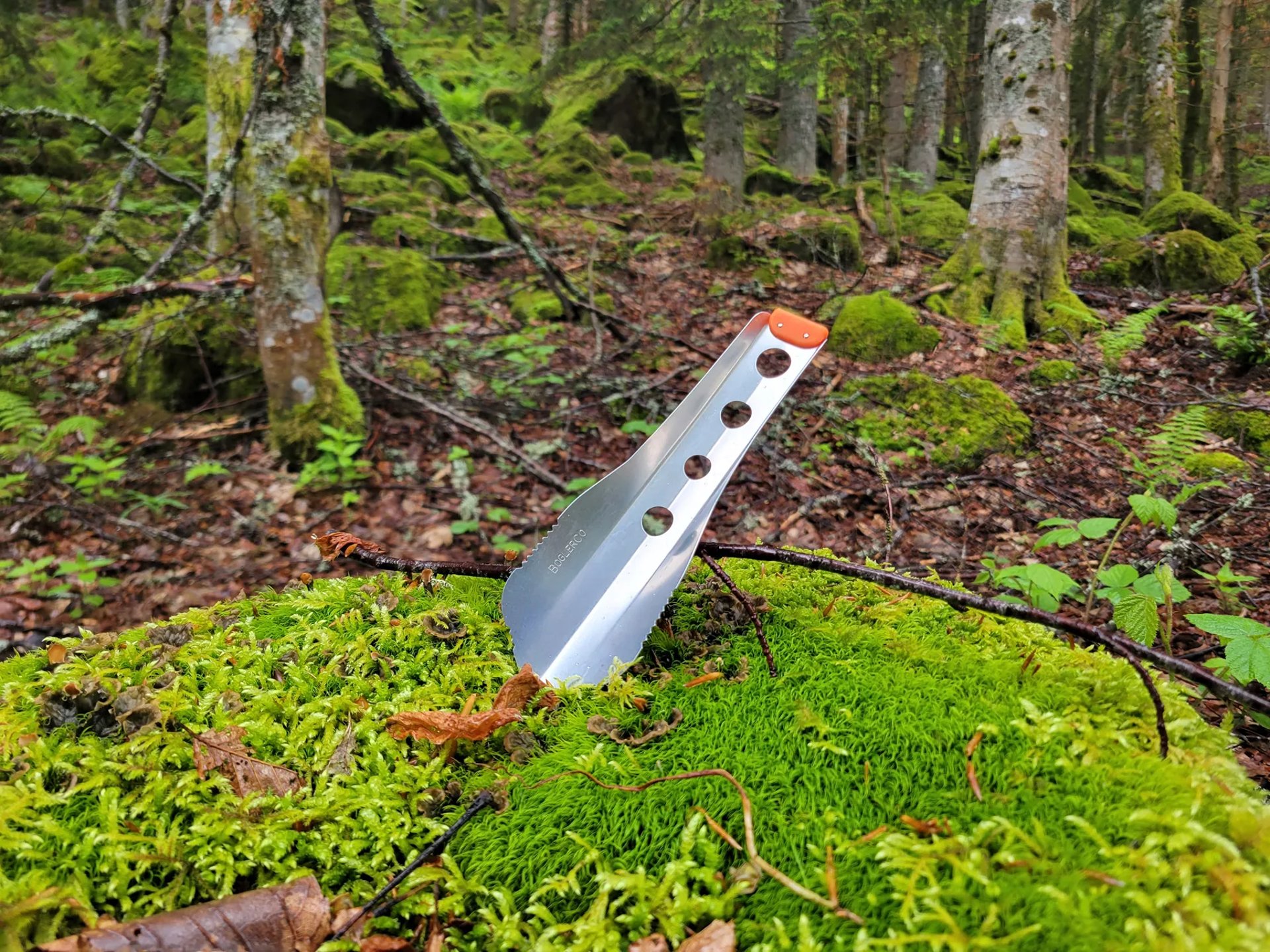boglerco trowel stuck into mossy ground