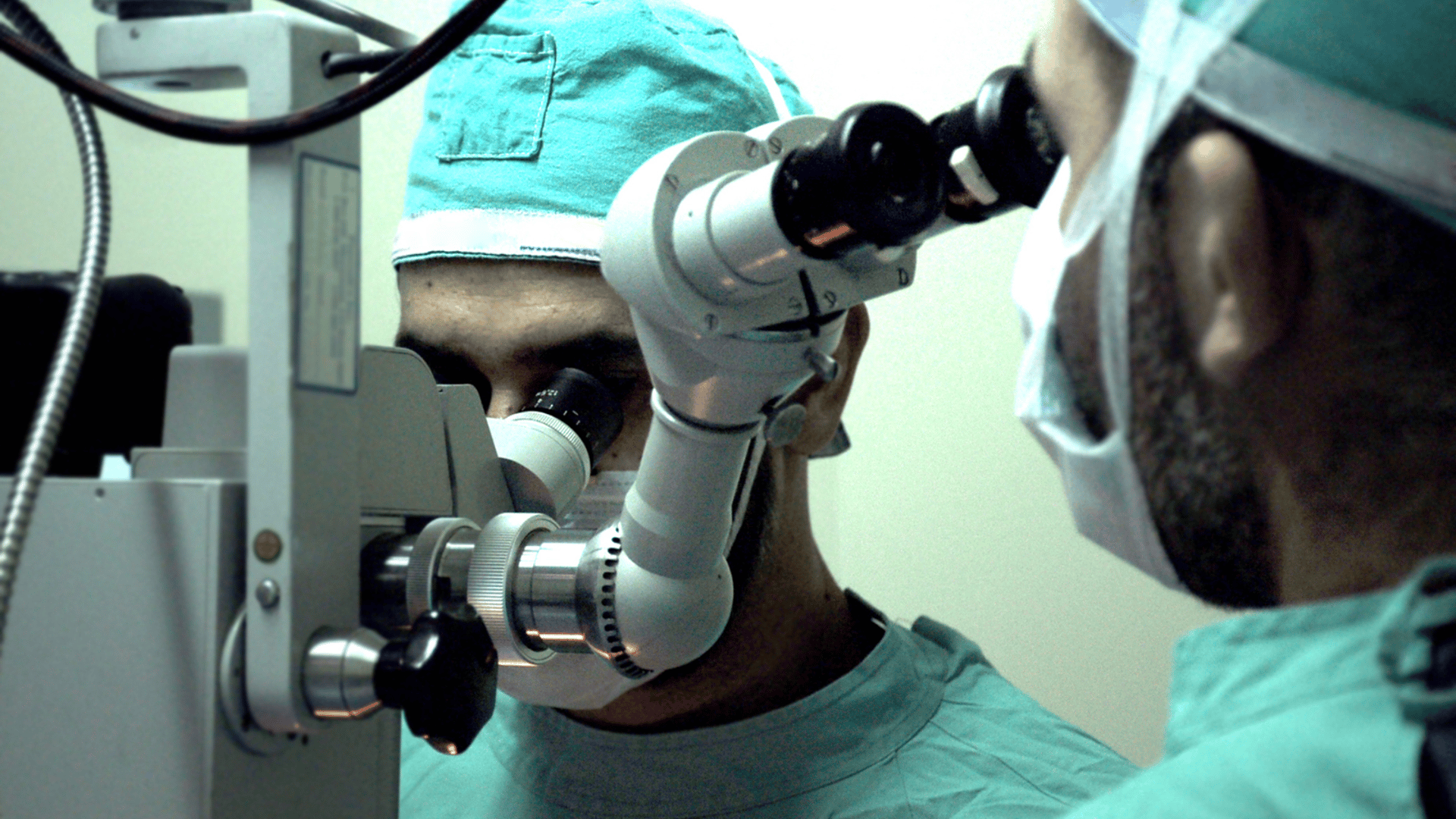 a group of different colored buttons on a pink surface