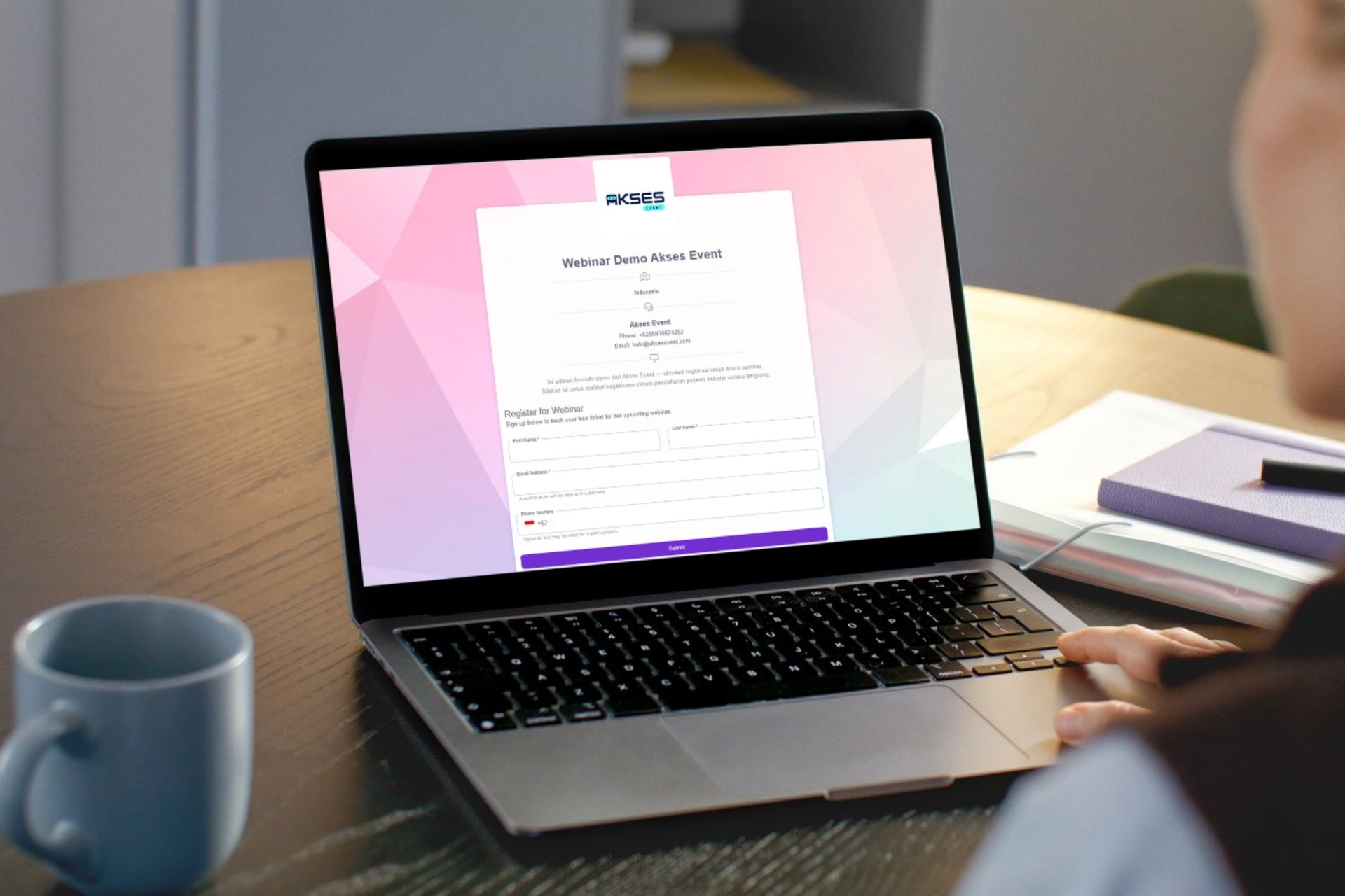 A person typing on a laptop on a desk
