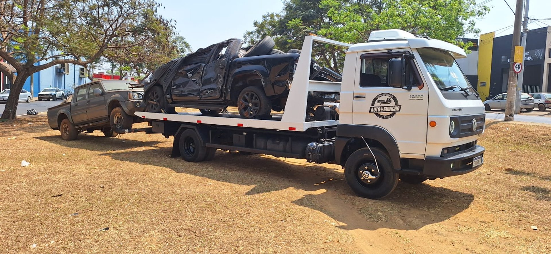 a blue car being loaded onto a flatbed truck
