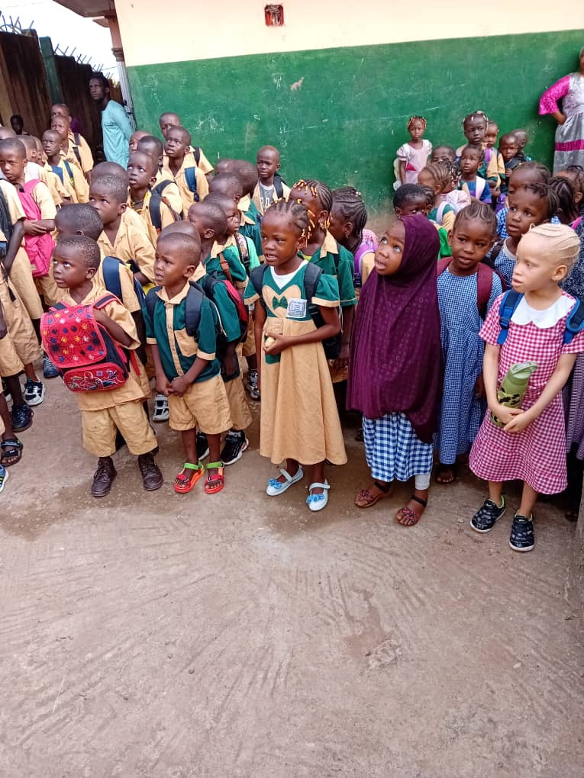 woman wearing yellow long-sleeved dress under white clouds and blue sky during daytime