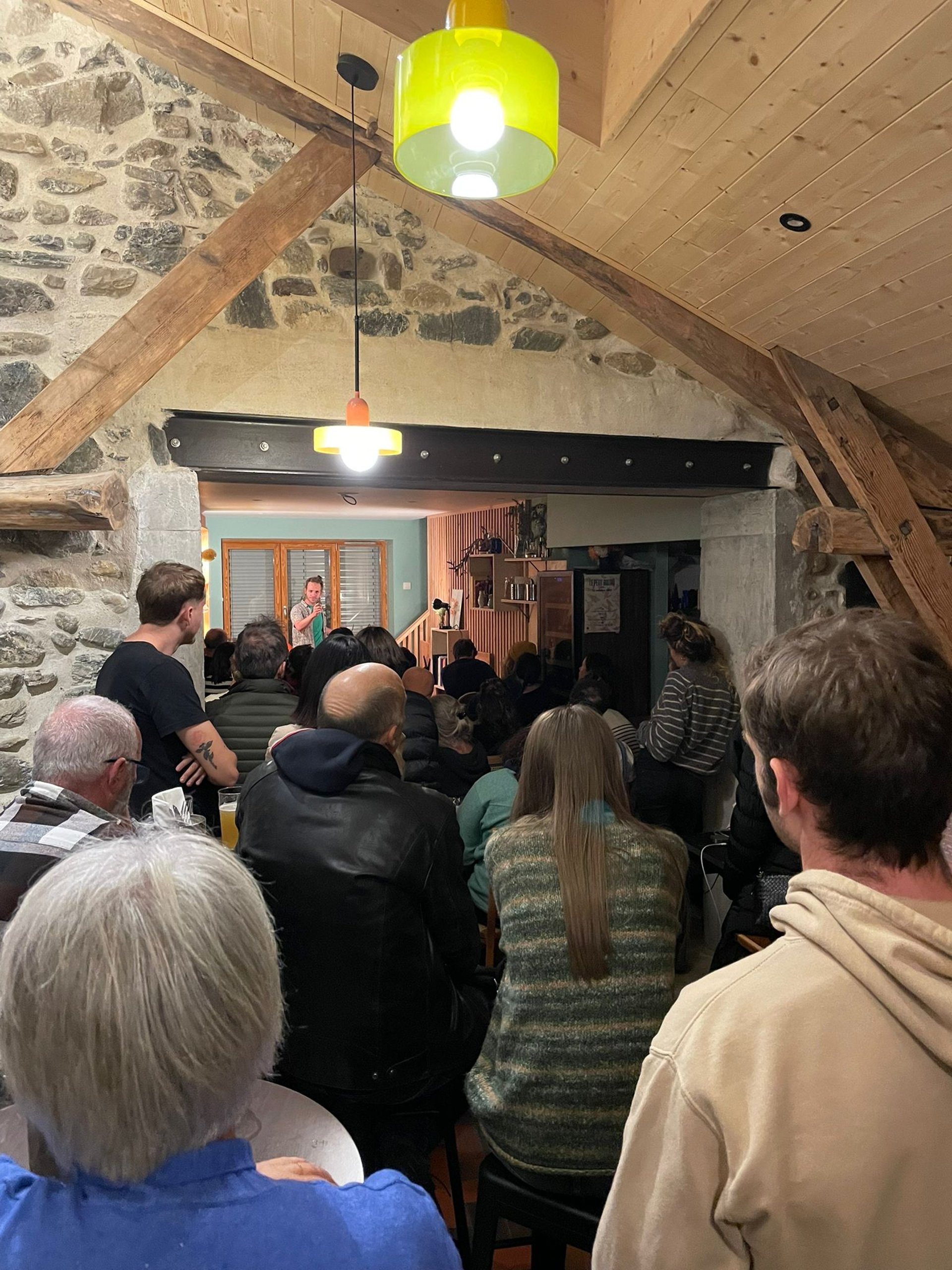 black kitchen appliance on kitchen island with pendant lights