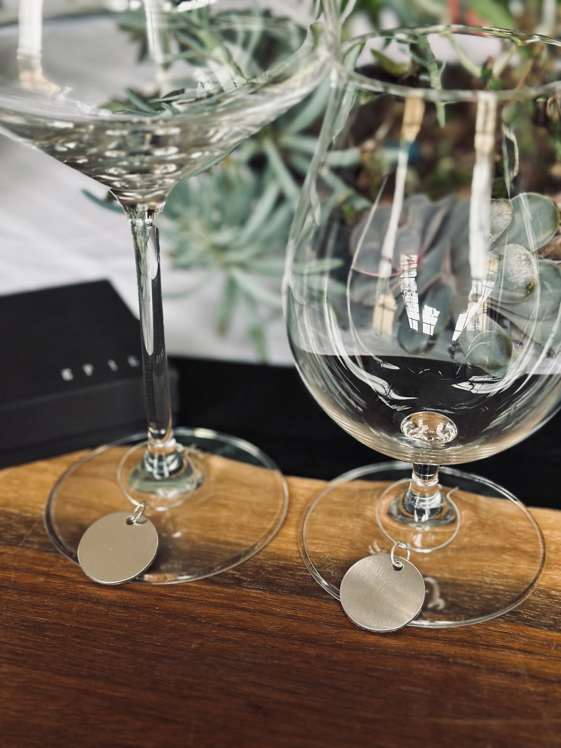 a wooden table topped with wine glasses and bottles