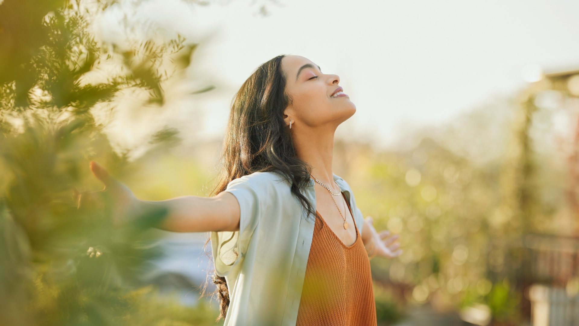 woman wearing yellow long-sleeved dress under white clouds and blue sky during daytime