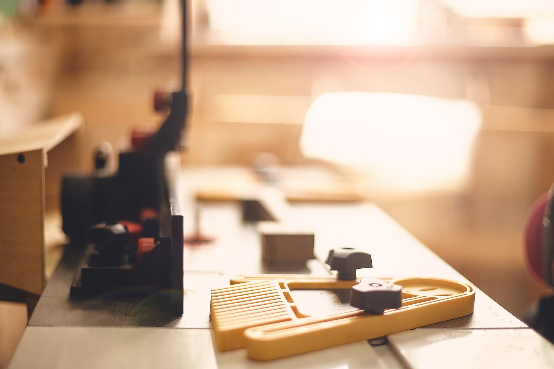 Sunlit workshop with router table, cast iron surface, and wooden blank — a warm glimpse into the CraftsAtlantic spirit