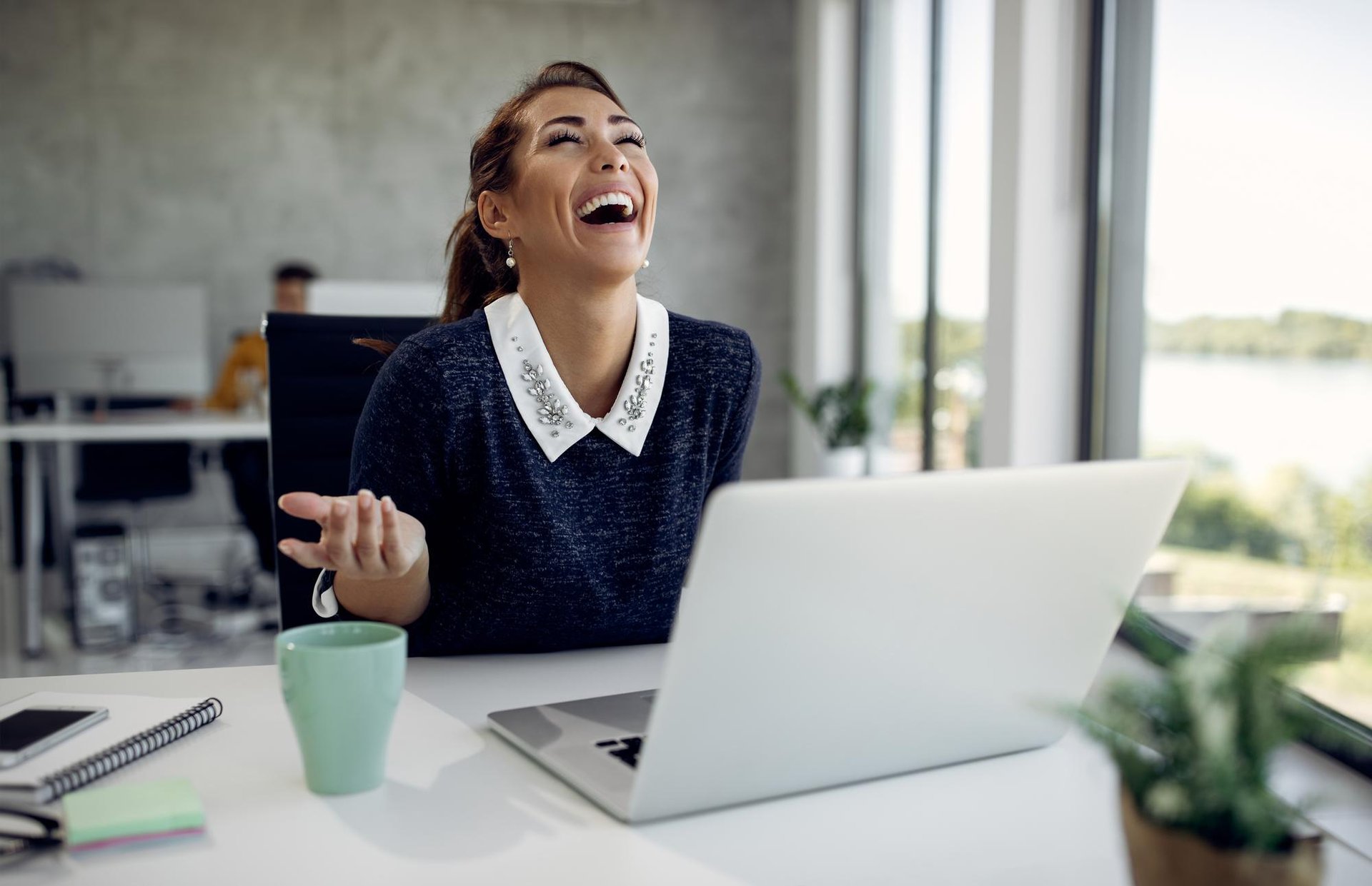two women talking while looking at laptop computer