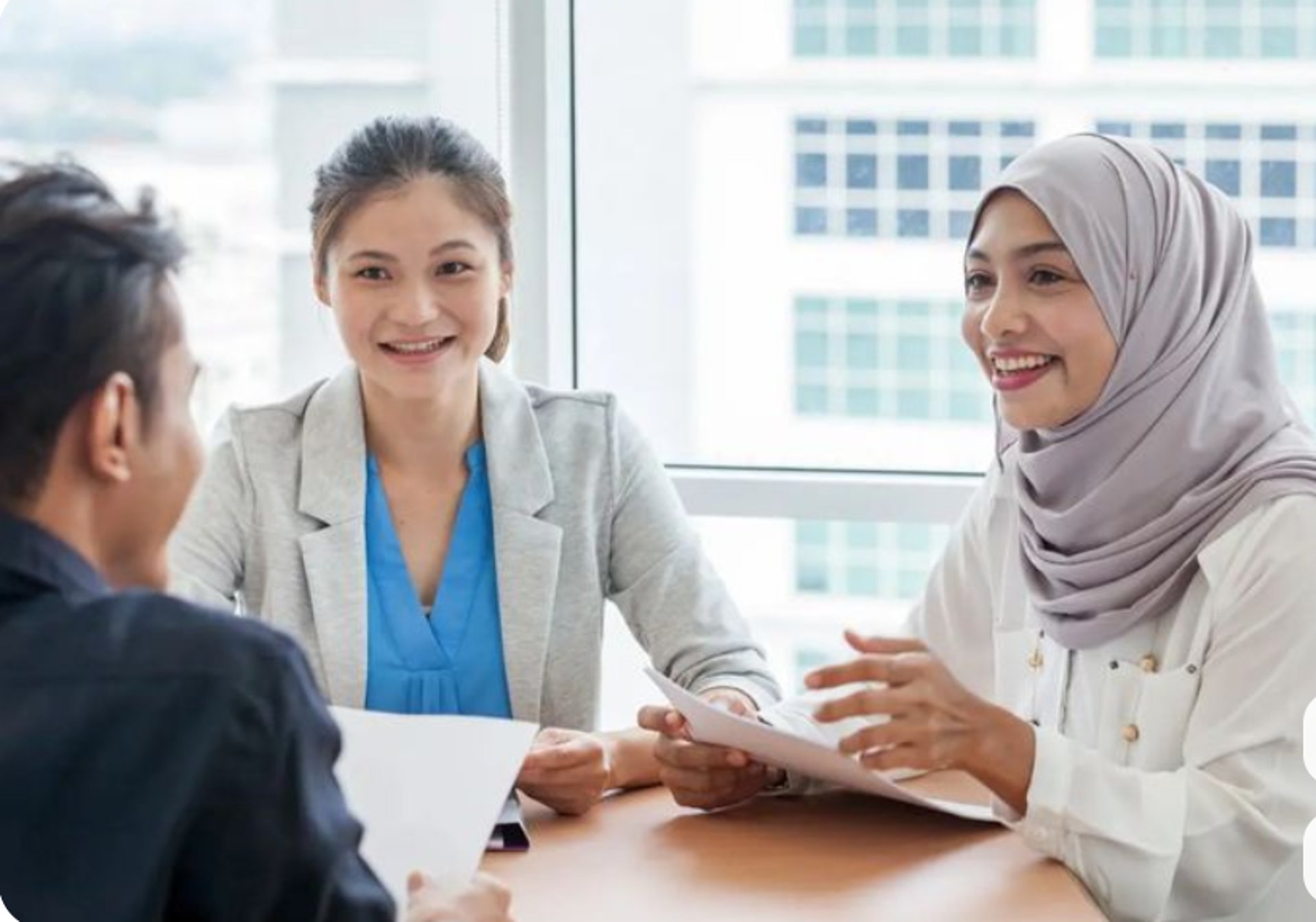 an abstract photo of a curved building with a blue sky in the background