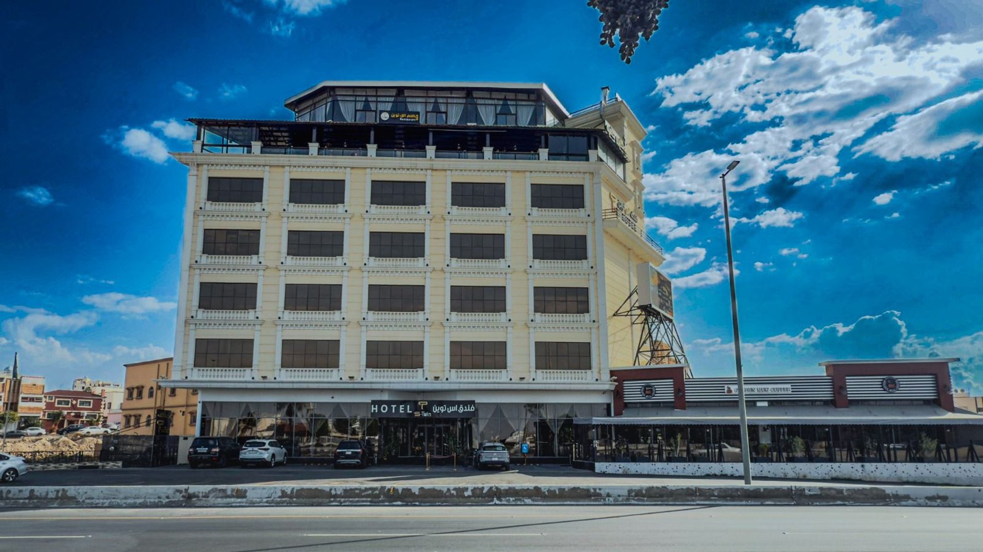 an abstract photo of a curved building with a blue sky in the background
