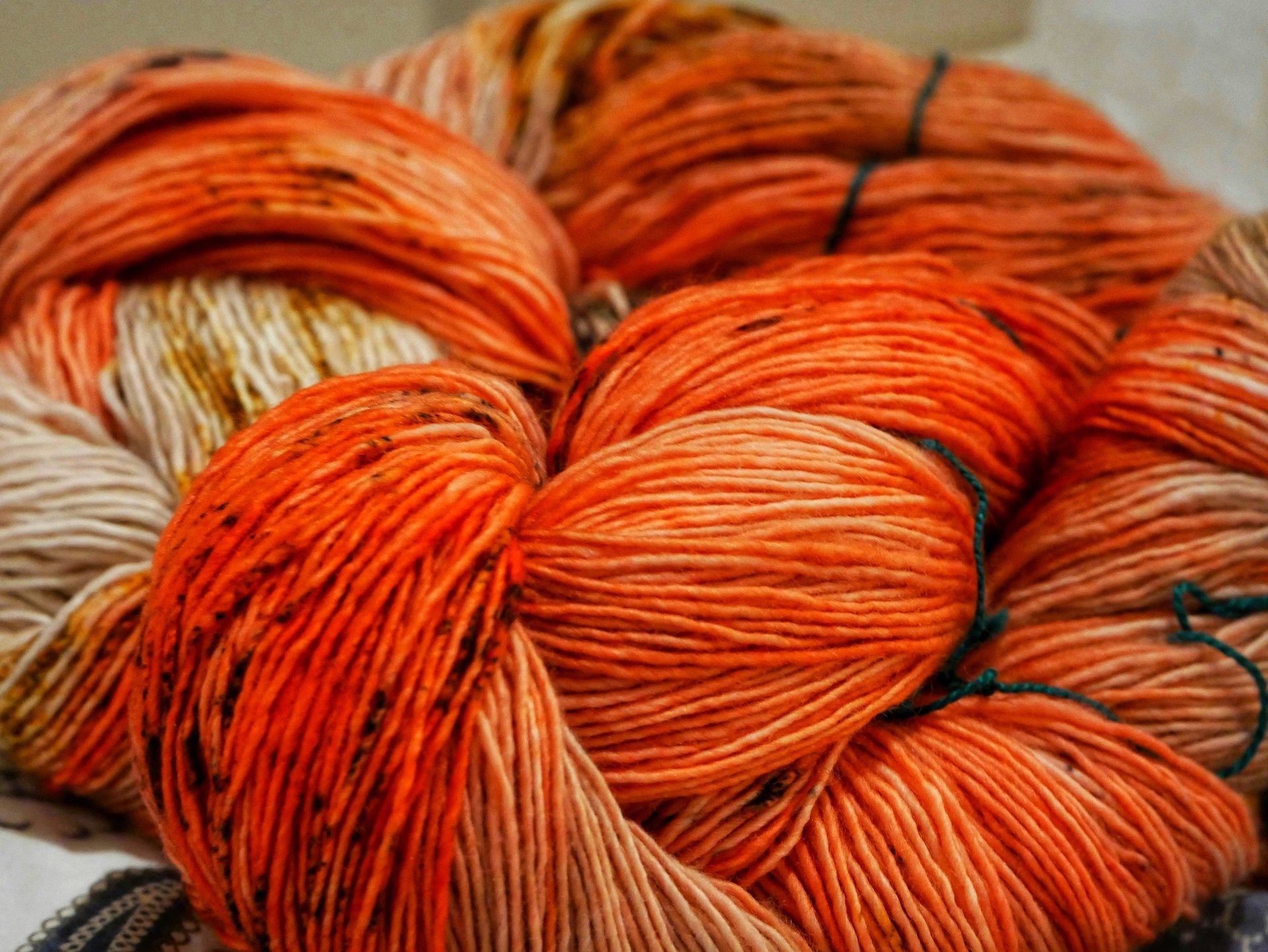 a bunch of yarn hanging on a brick wall