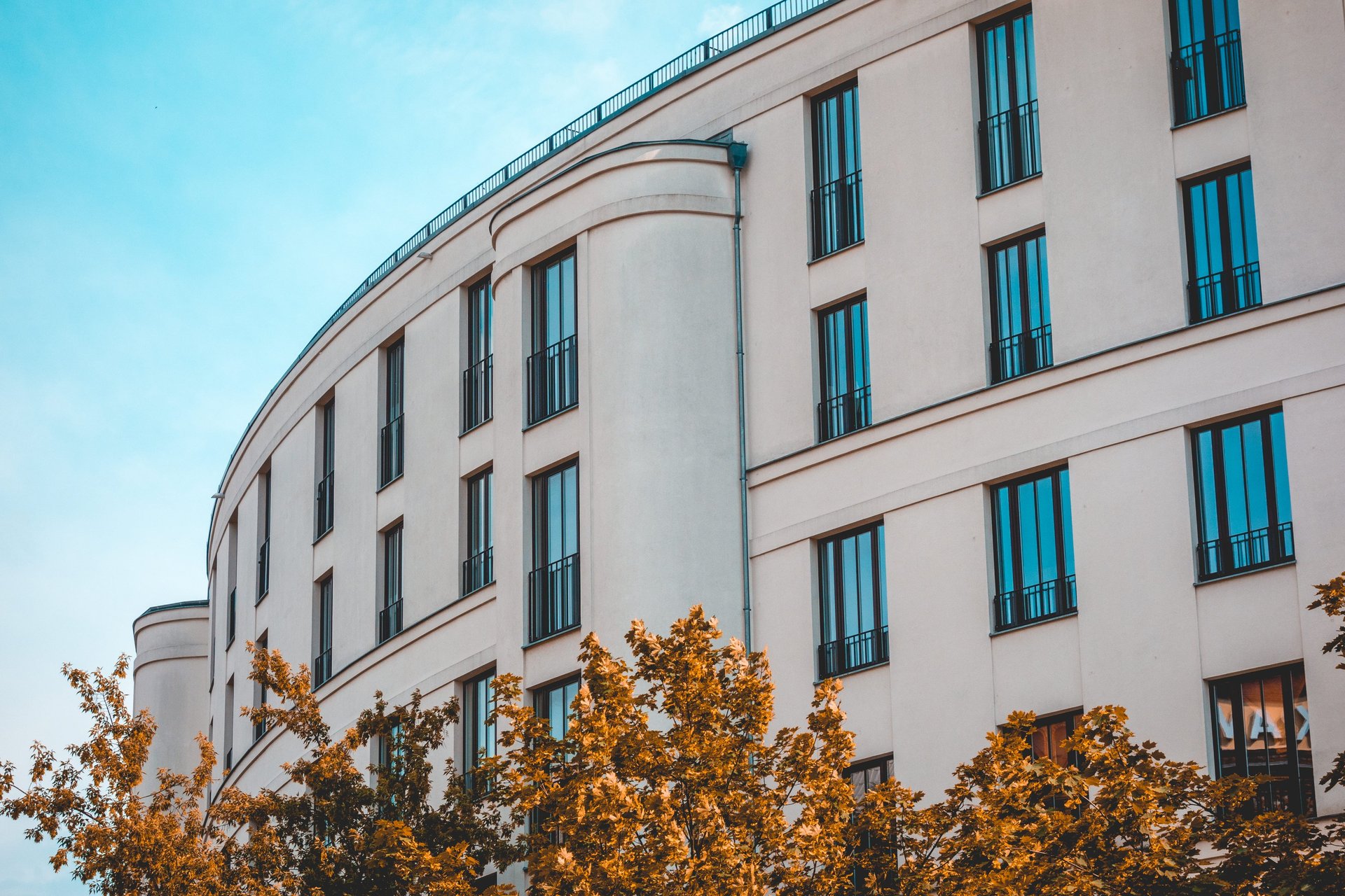 low-angle photo of Hotel lighted signage on top of brown building during nighttime