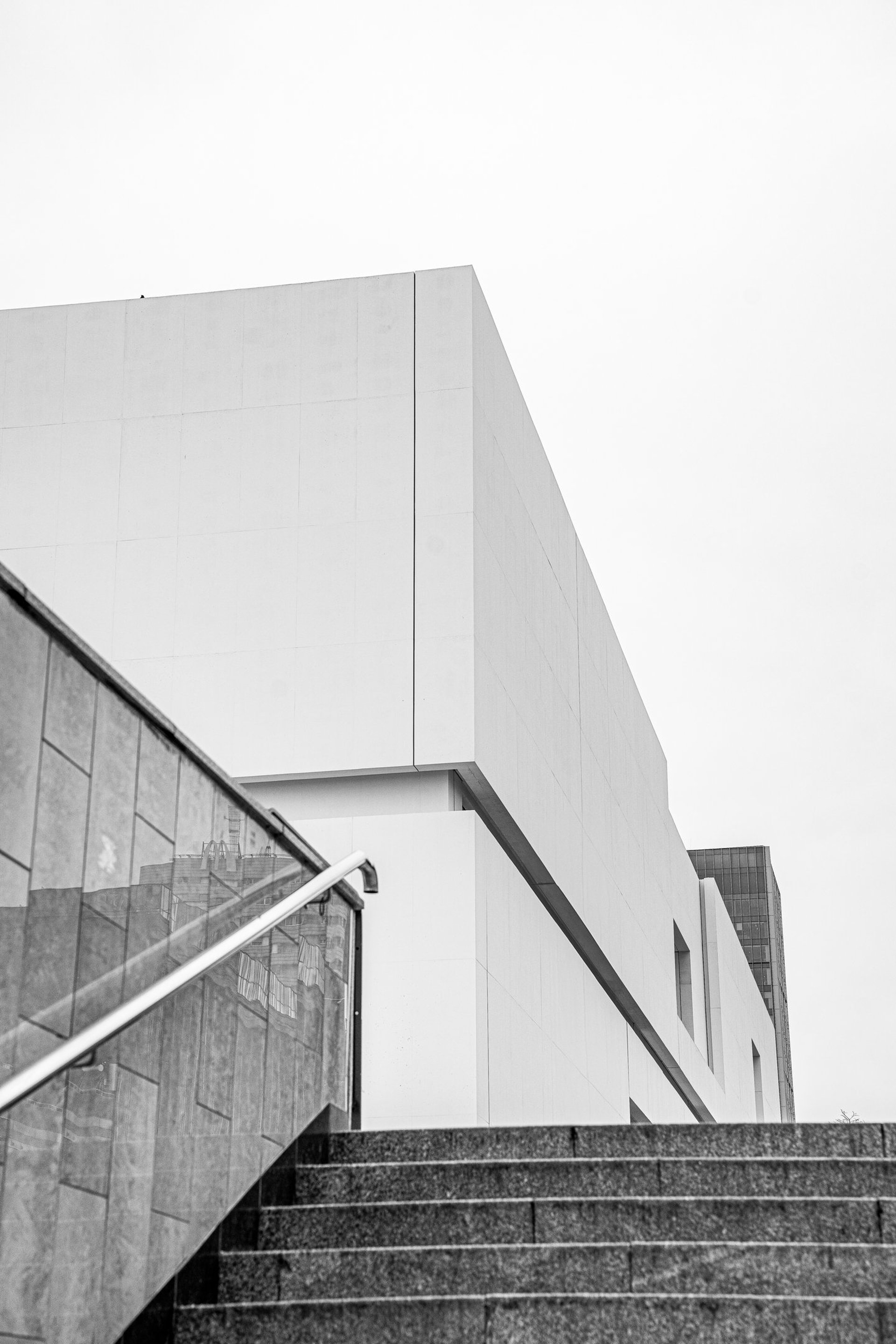 an abstract photo of a curved building with a blue sky in the background