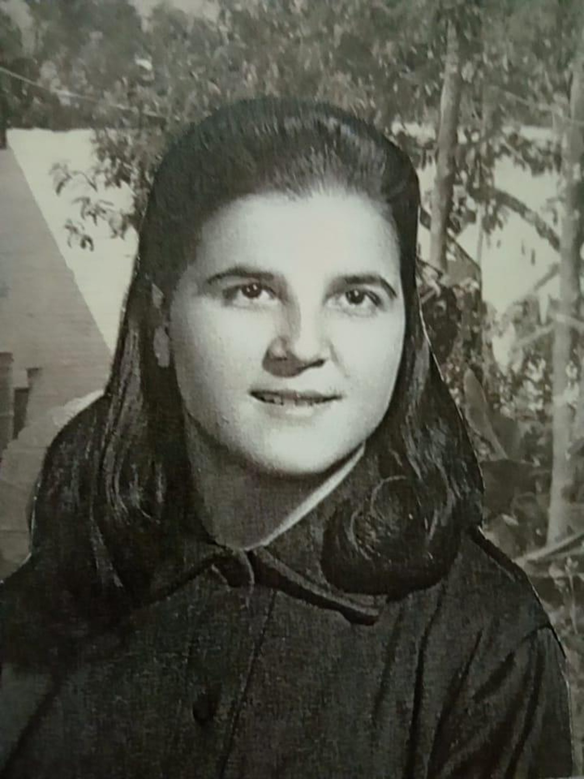 silhouette of man and woman standing near body of water during sunset