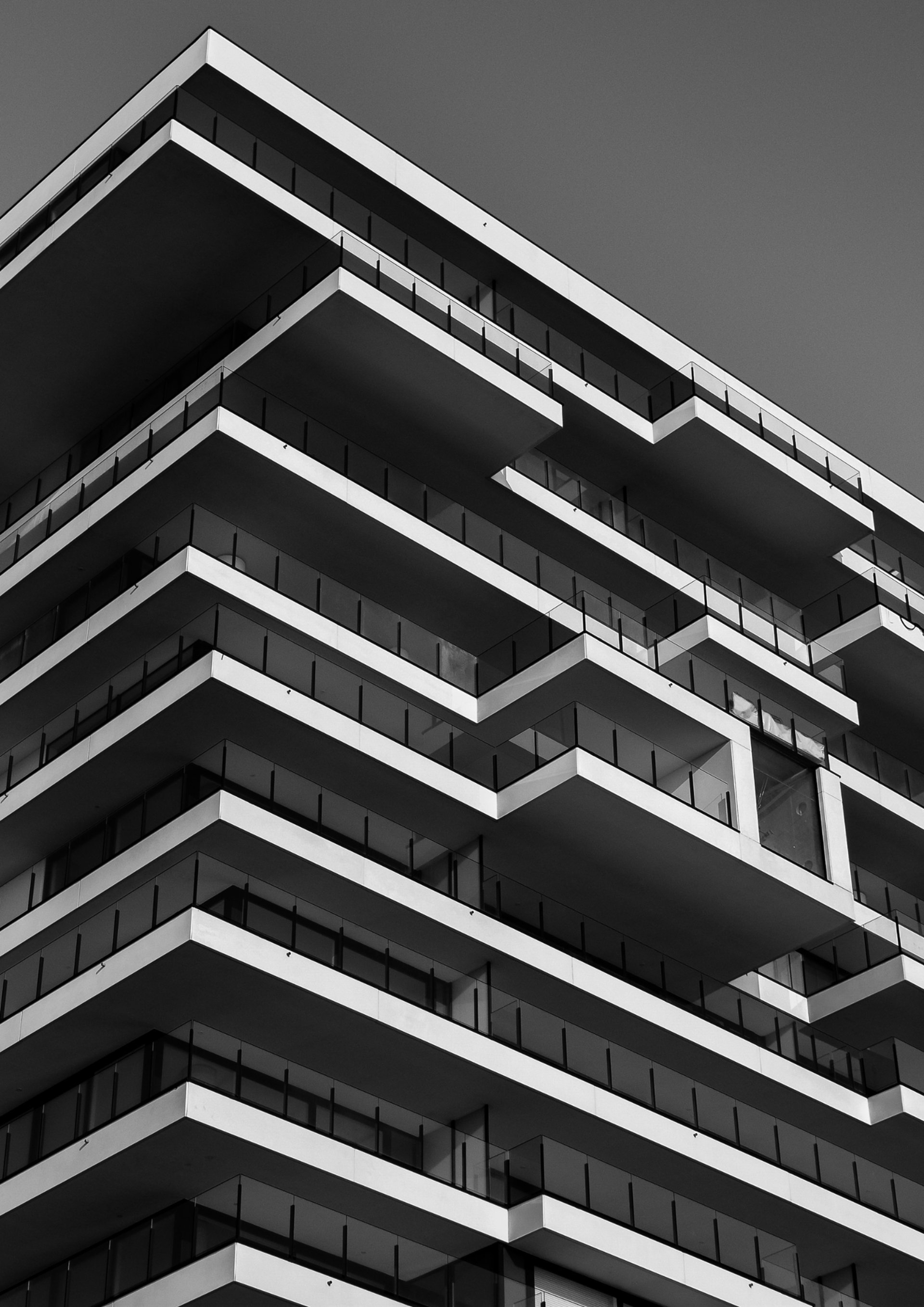 an abstract photo of a curved building with a blue sky in the background