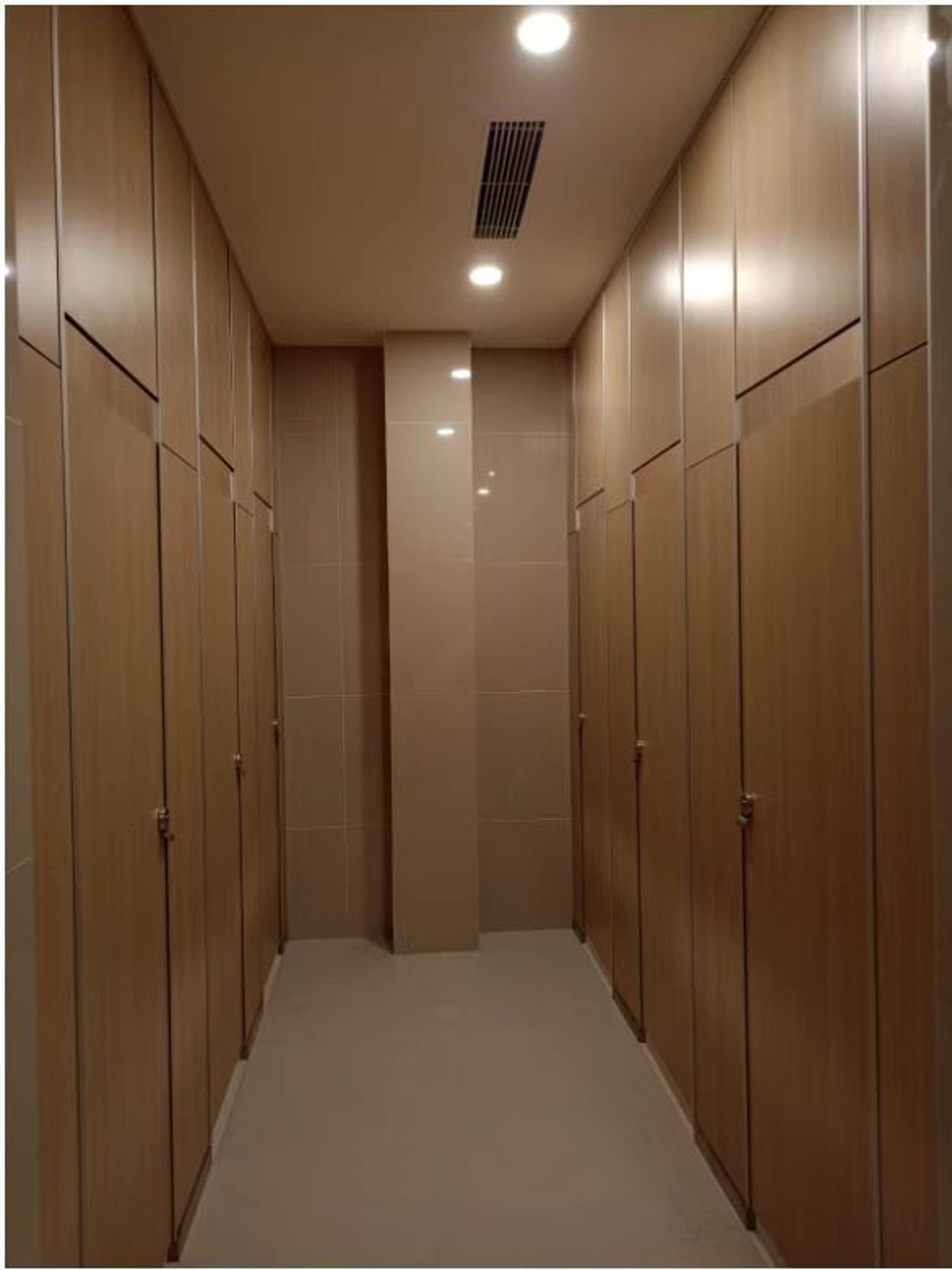 empty hallway between concrete buildings during daytime