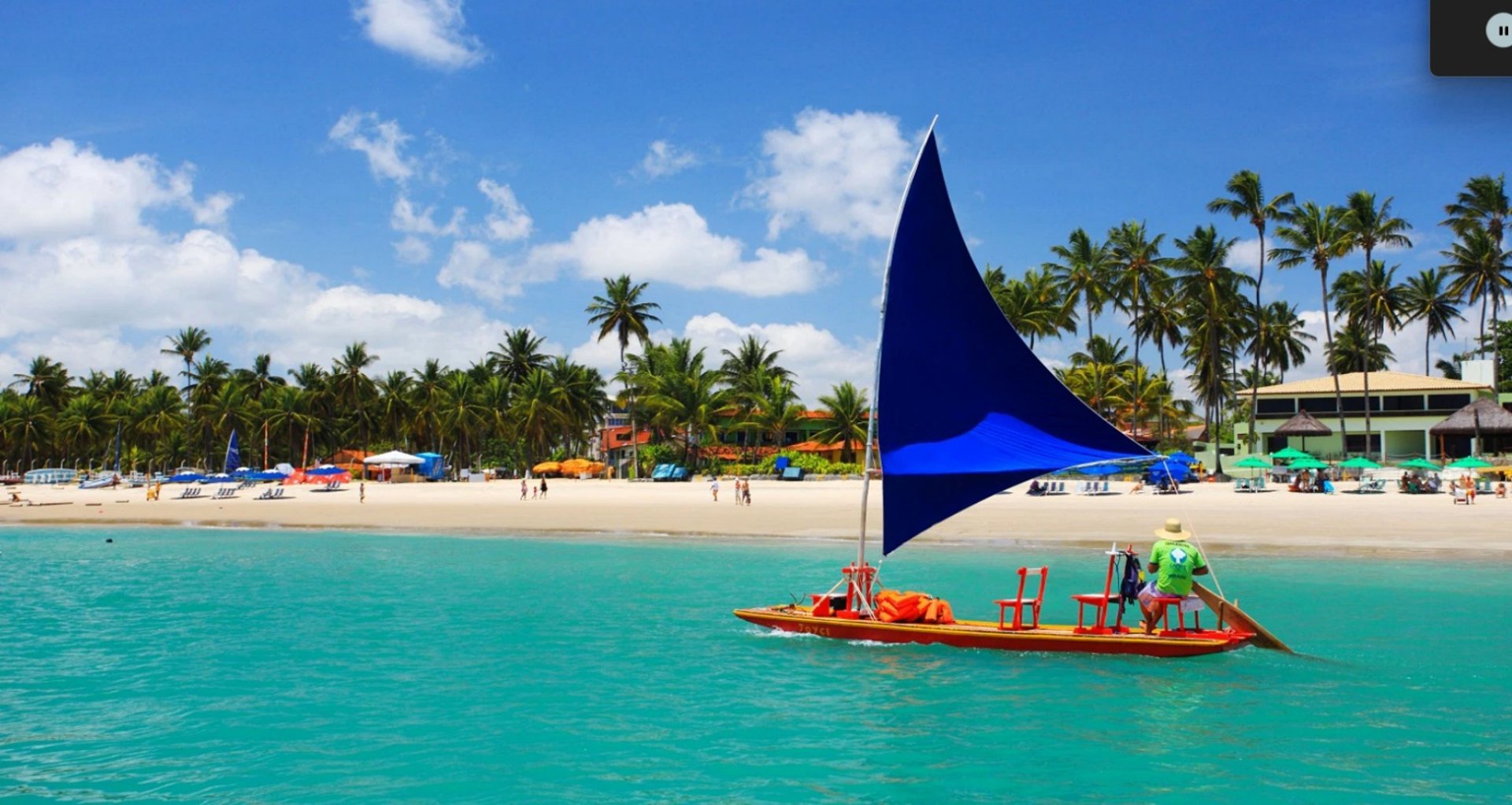 2 women in yellow and blue bikini on brown wooden boat on blue sea during daytime