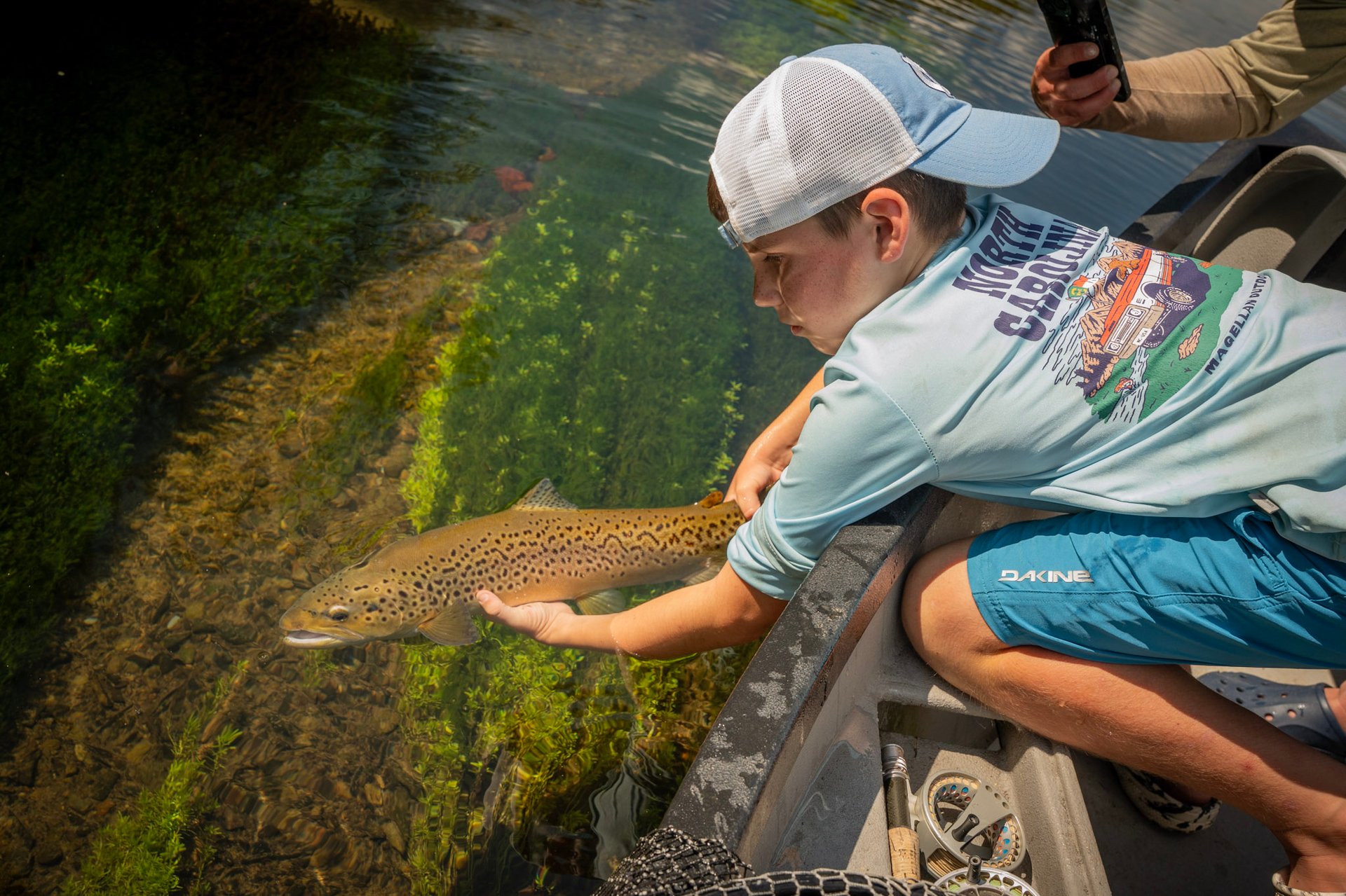 Head guide John Stunkard stands with Joe as they capture a new personal best brown trout.