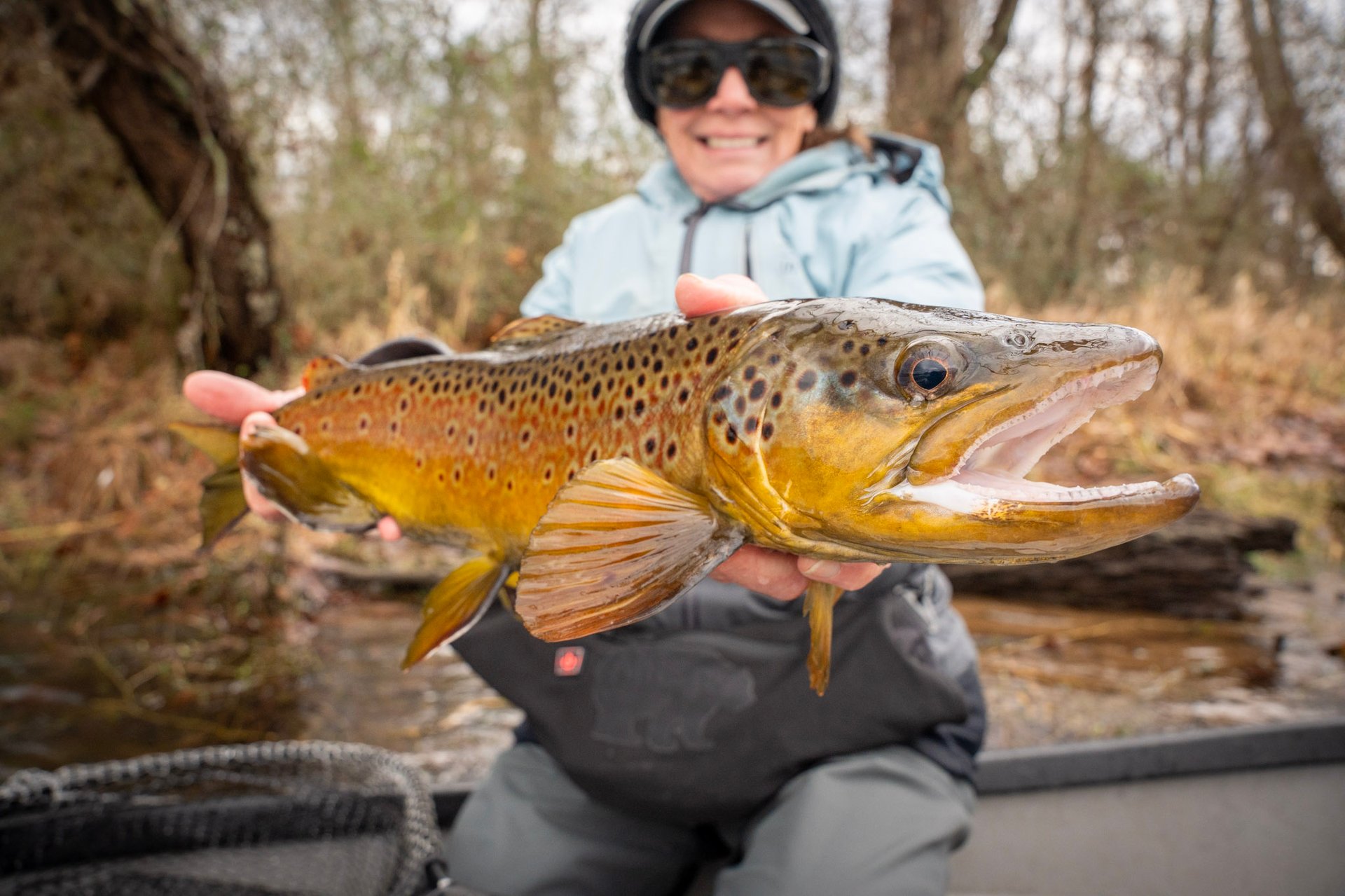 Head guide John Stunkard stands with Joe as they capture a new personal best brown trout.