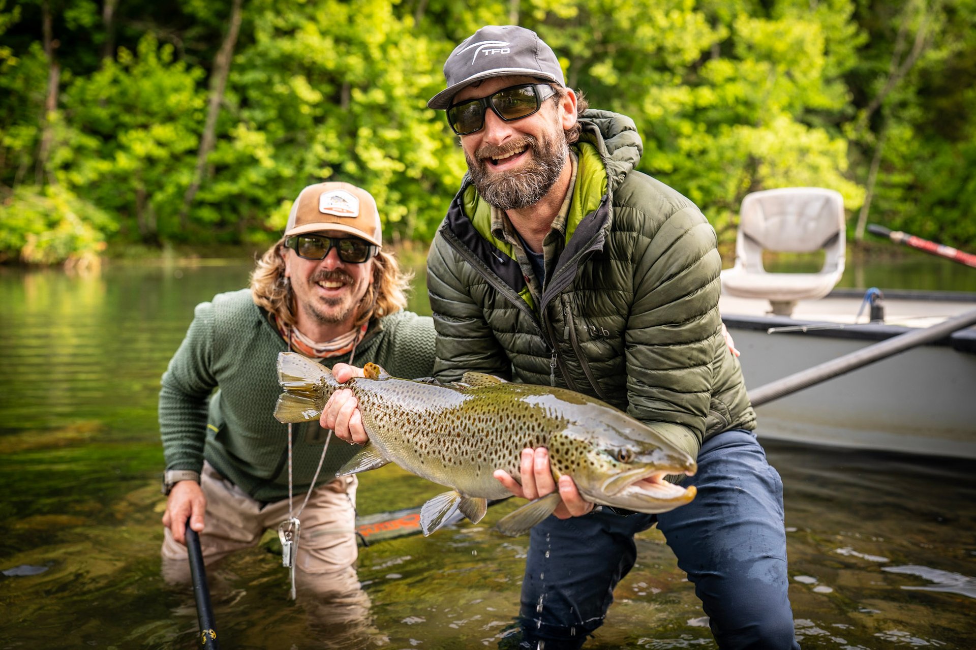 Head guide John Stunkard stands with Joe as they capture a new personal best brown trout.