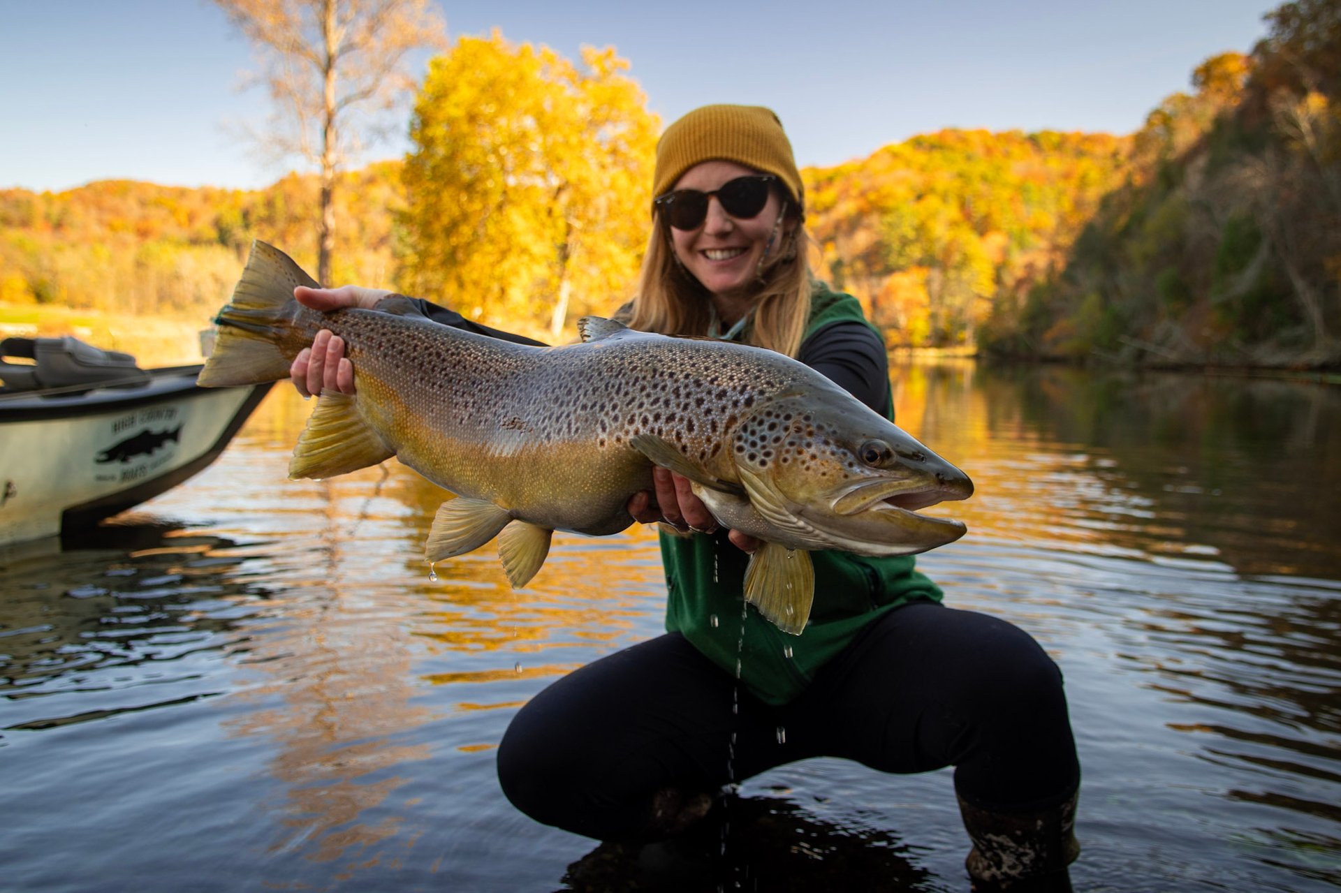 A beautiful female angler with a huge brown trout.