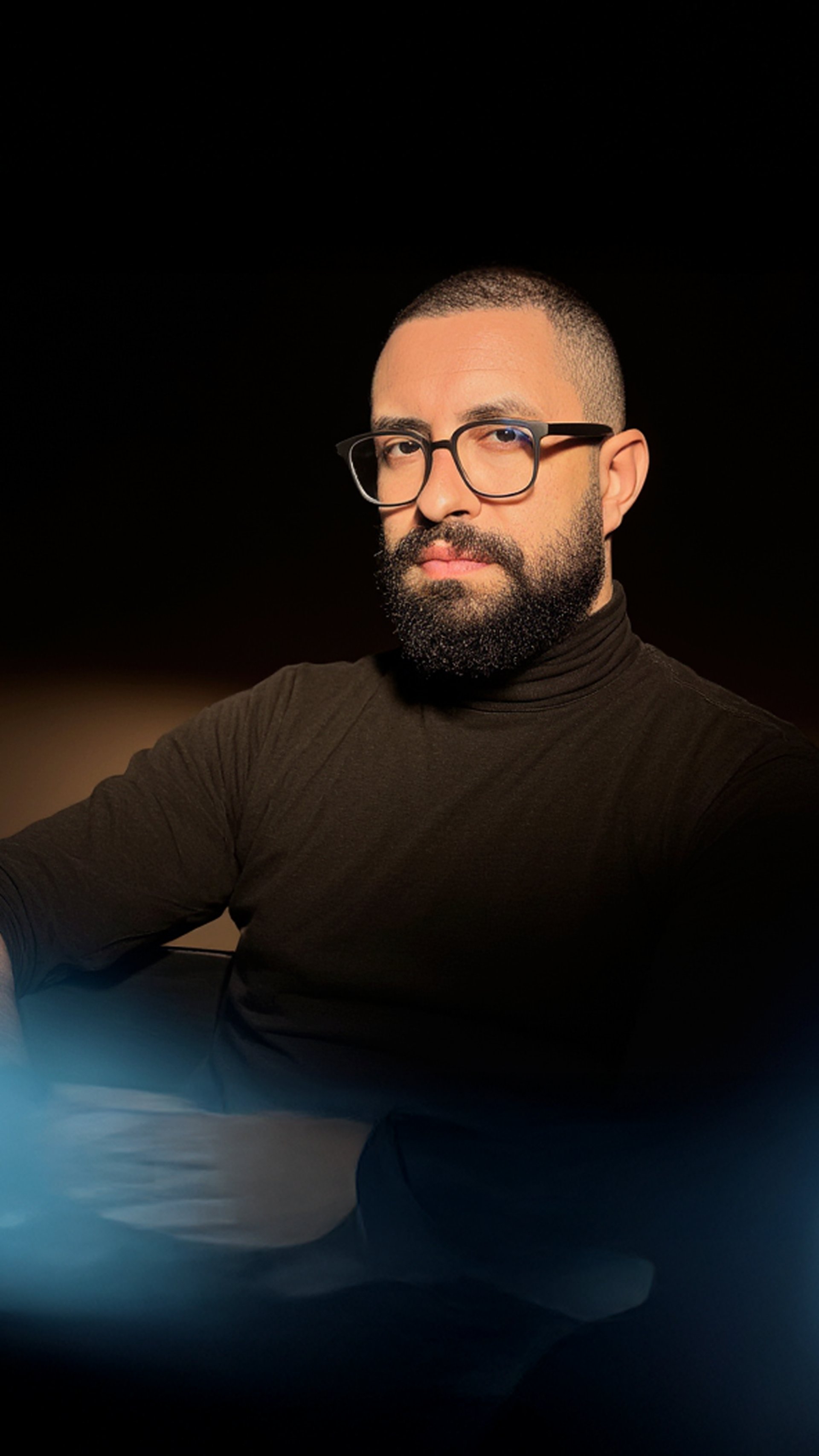 an abstract photo of a curved building with a blue sky in the background