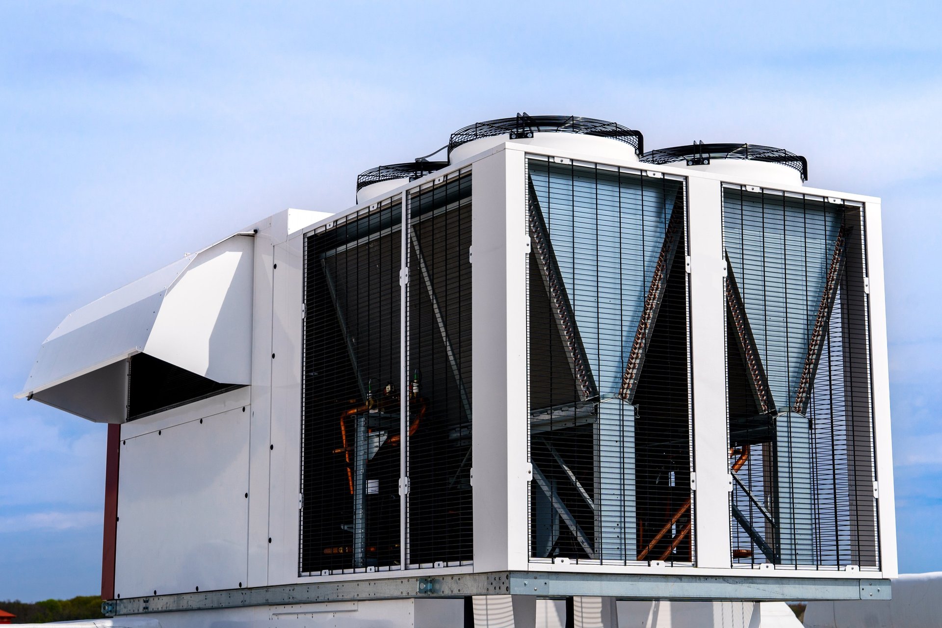 an abstract photo of a curved building with a blue sky in the background