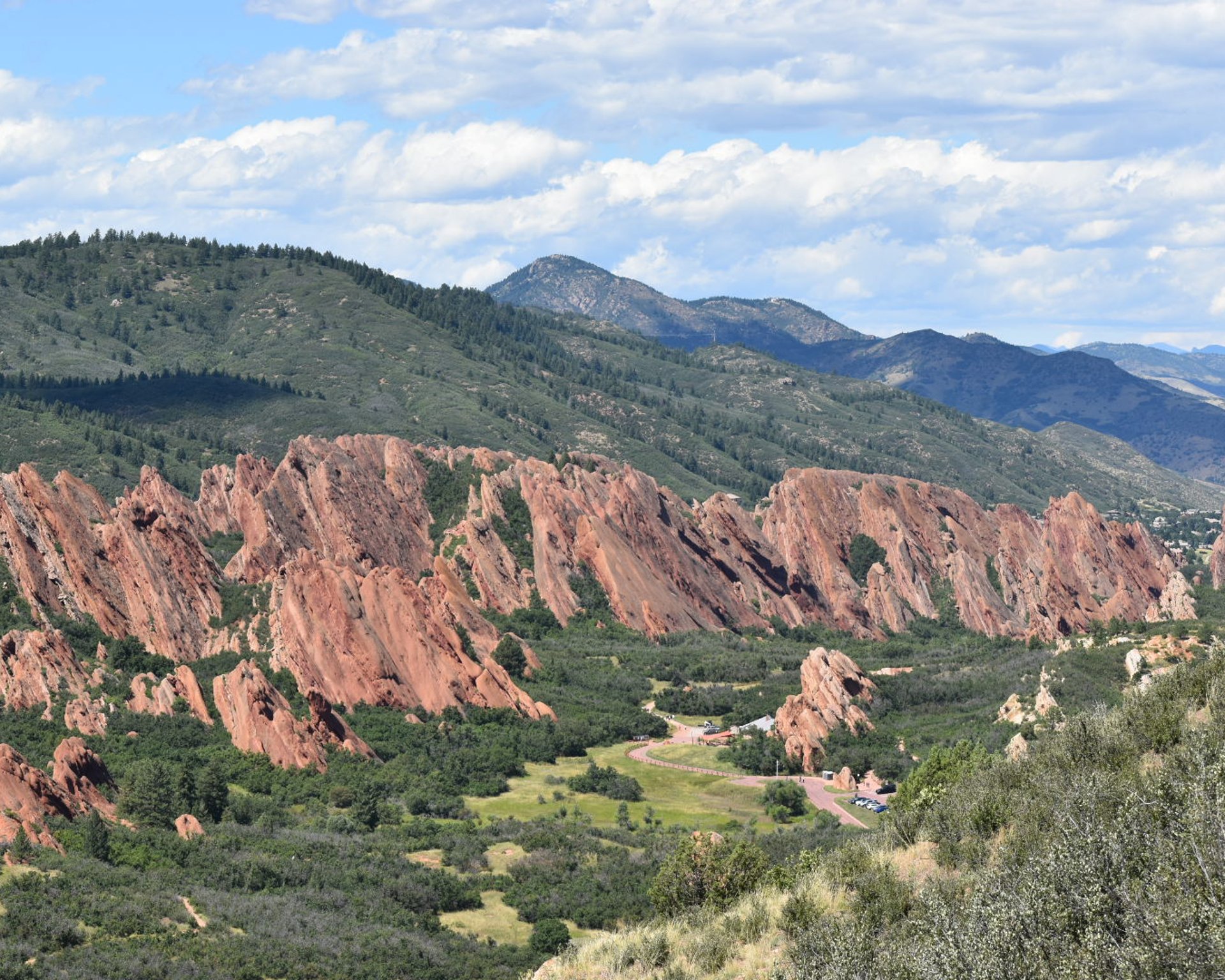 woman wearing yellow long-sleeved dress under white clouds and blue sky during daytime