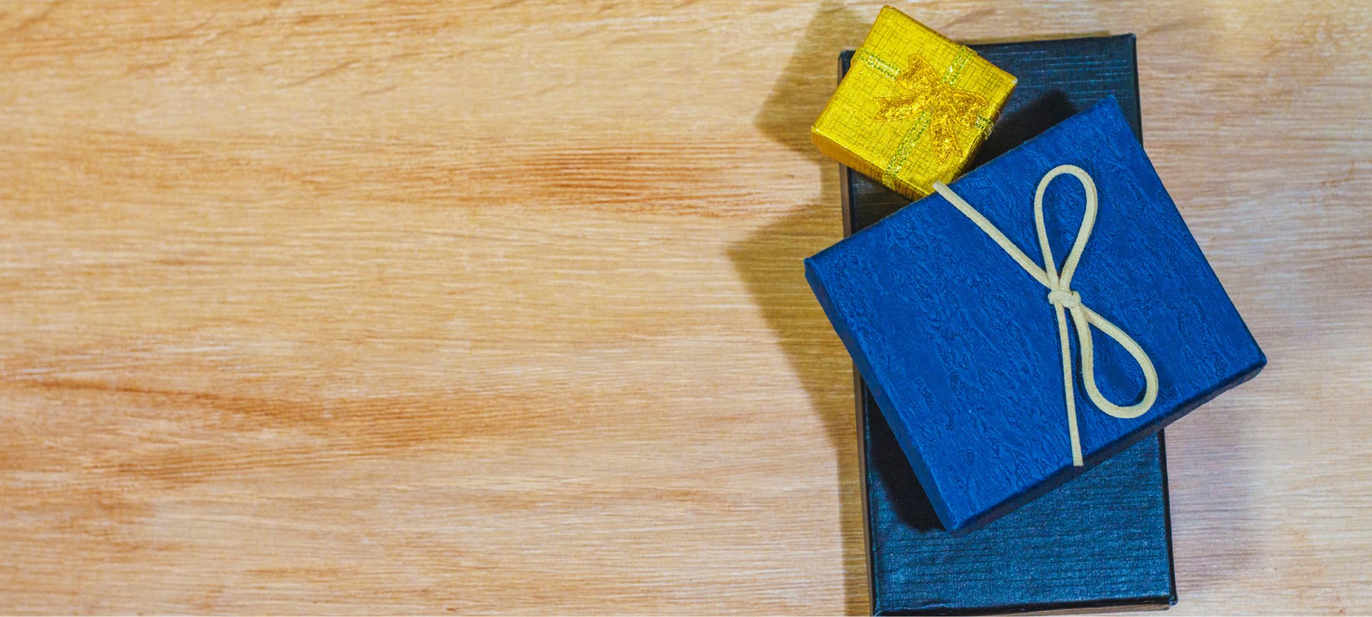a yellow box with a blue ribbon tied around it