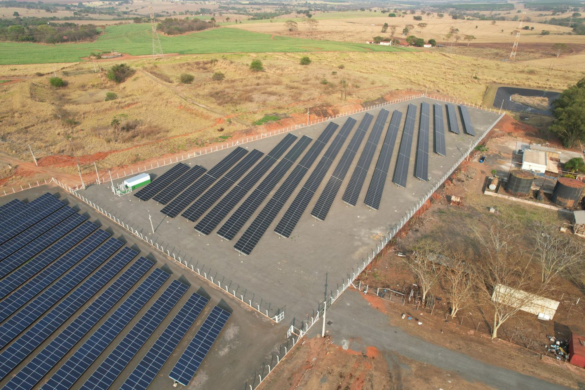 aerial photography of grass field with blue solar panels