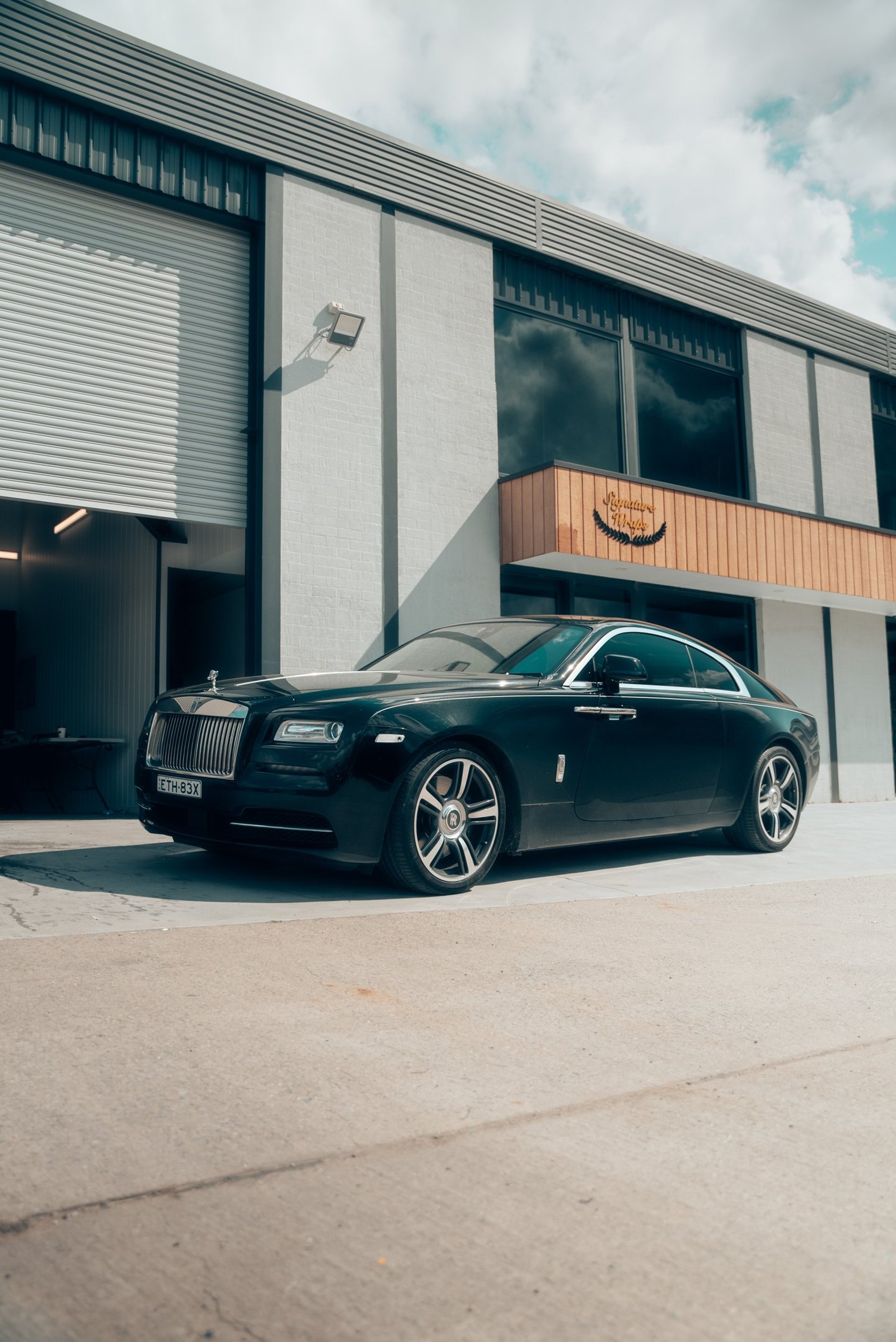 black porsche 911 parked near white wall