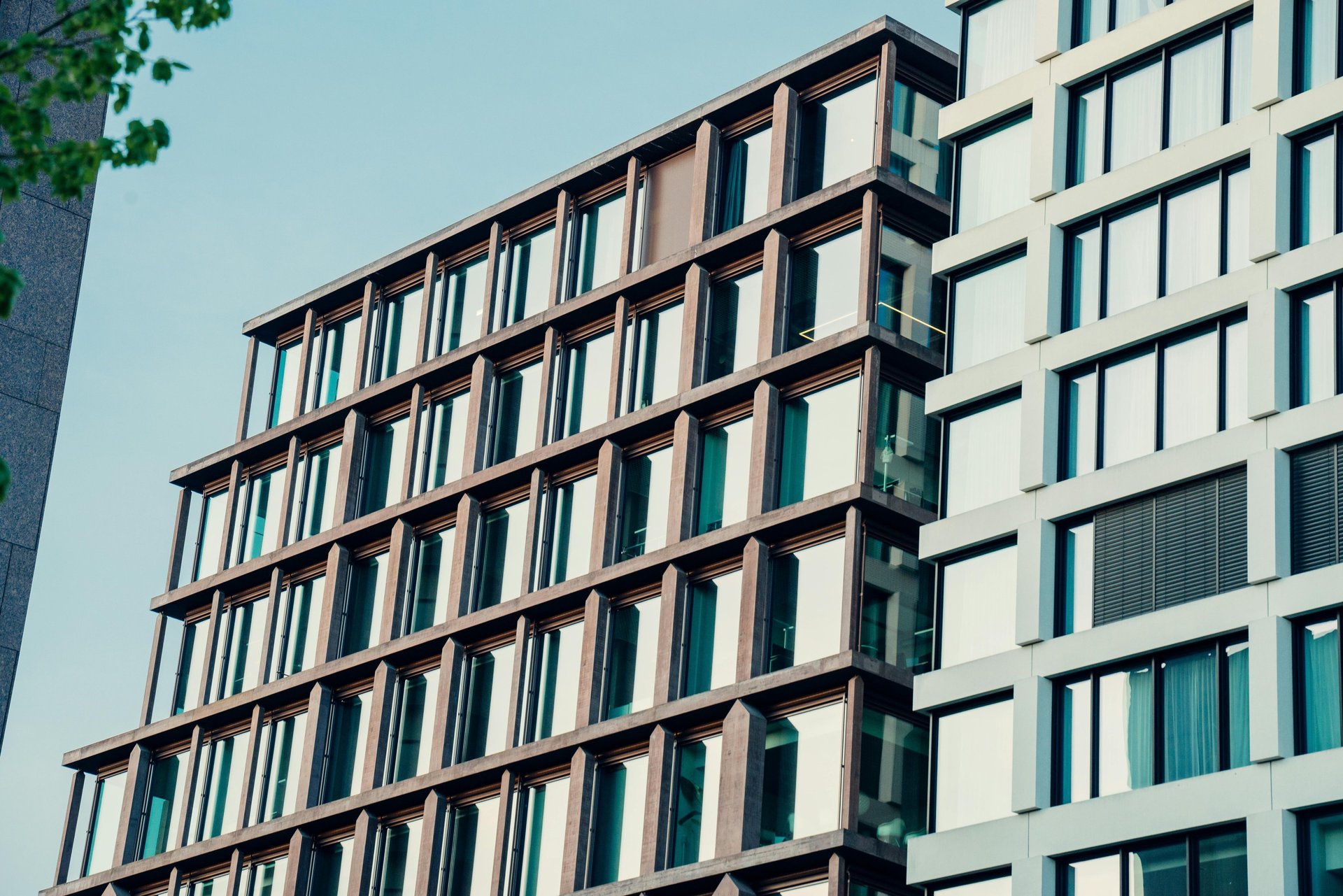 an abstract photo of a curved building with a blue sky in the background