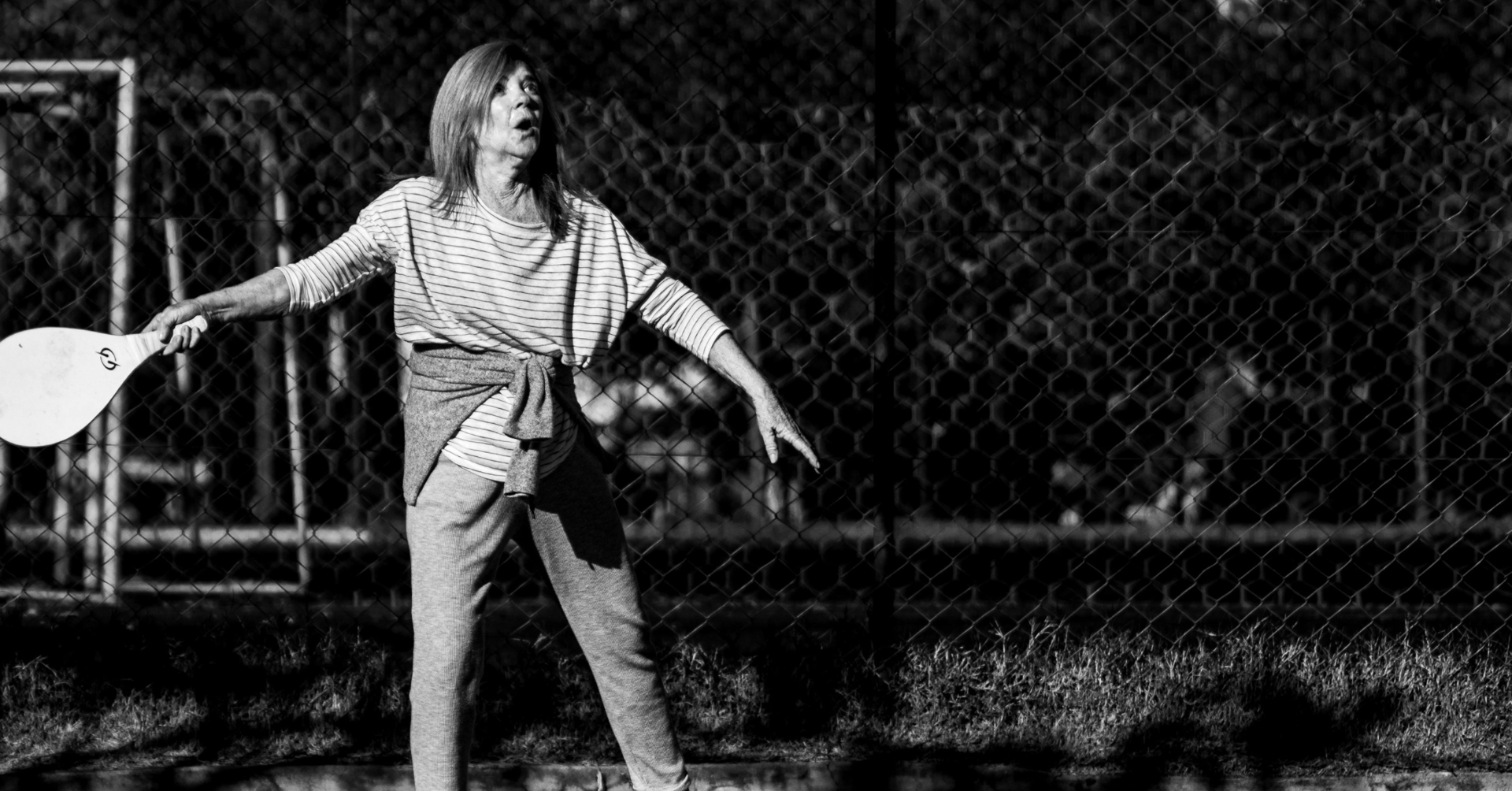 a man and woman shaking hands on a tennis court
